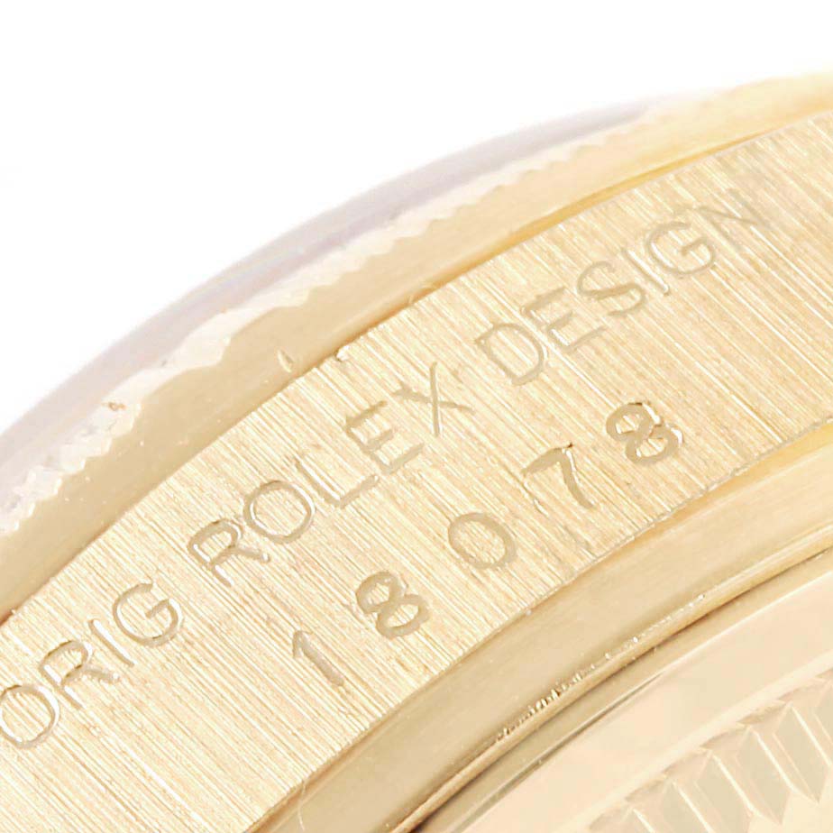 This image shows a close-up of the side of a Rolex President 18078 Men's Yellow Gold Silver Dial 18078 Men's Yellow Gold Silver Dial model watch, focusing on the engraved text on the case.