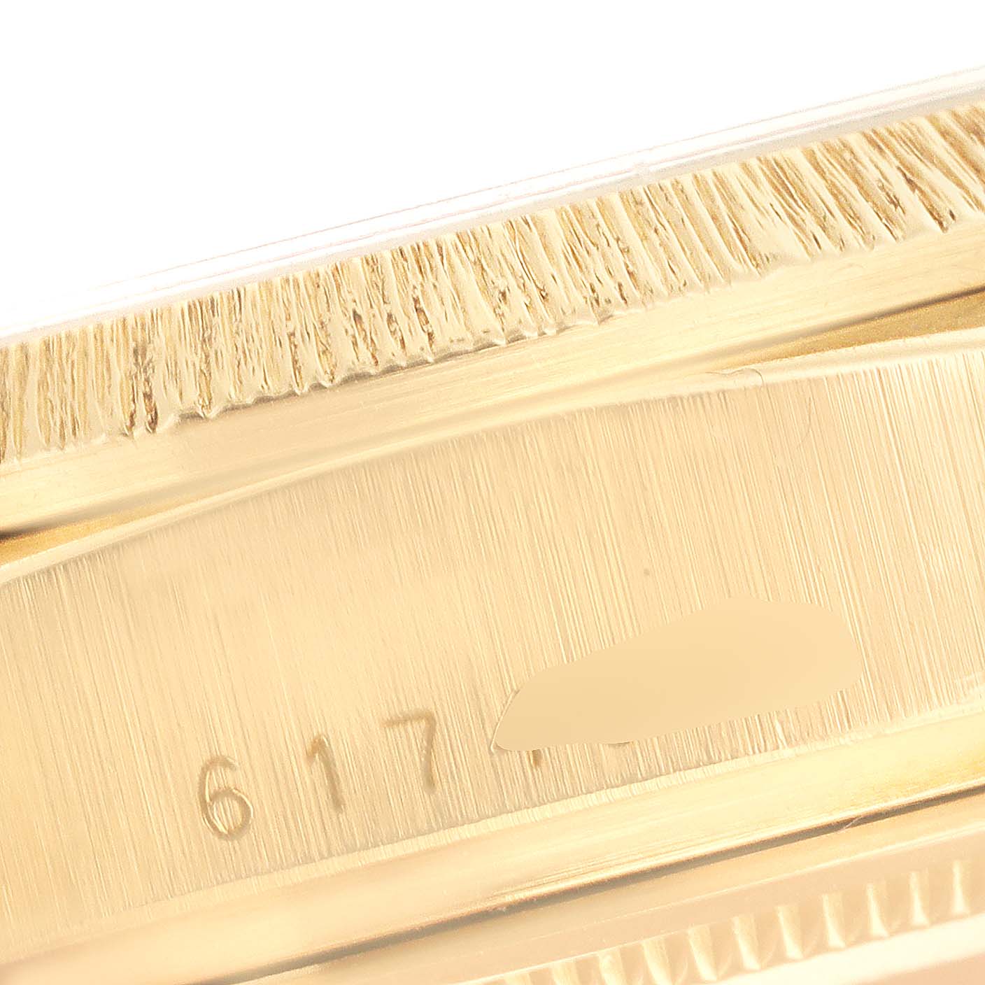 This image shows a close-up of the side case and bezel edge of a Rolex President 18078 Men's Yellow Gold Silver Dial 18078 Men's Yellow Gold Silver Dial model watch, highlighting some serial numbers.