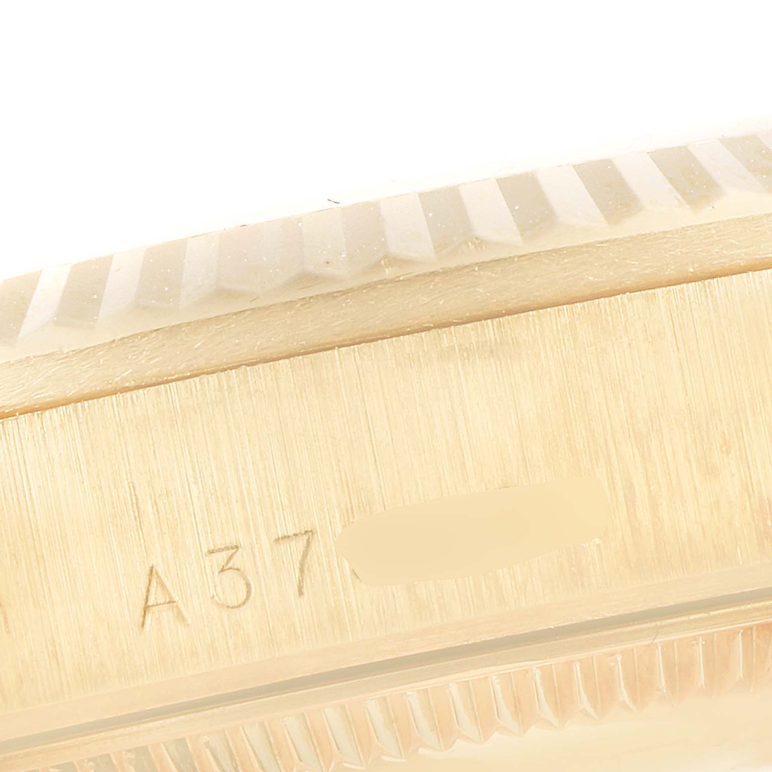 The image shows a close-up of the bezel and case side of a Rolex President 78278 Women
s Yellow Gold Mother of Pearl Dial 78278 Women
s Yellow Gold Mother of Pearl Dial model watch, displaying part of the serial number.