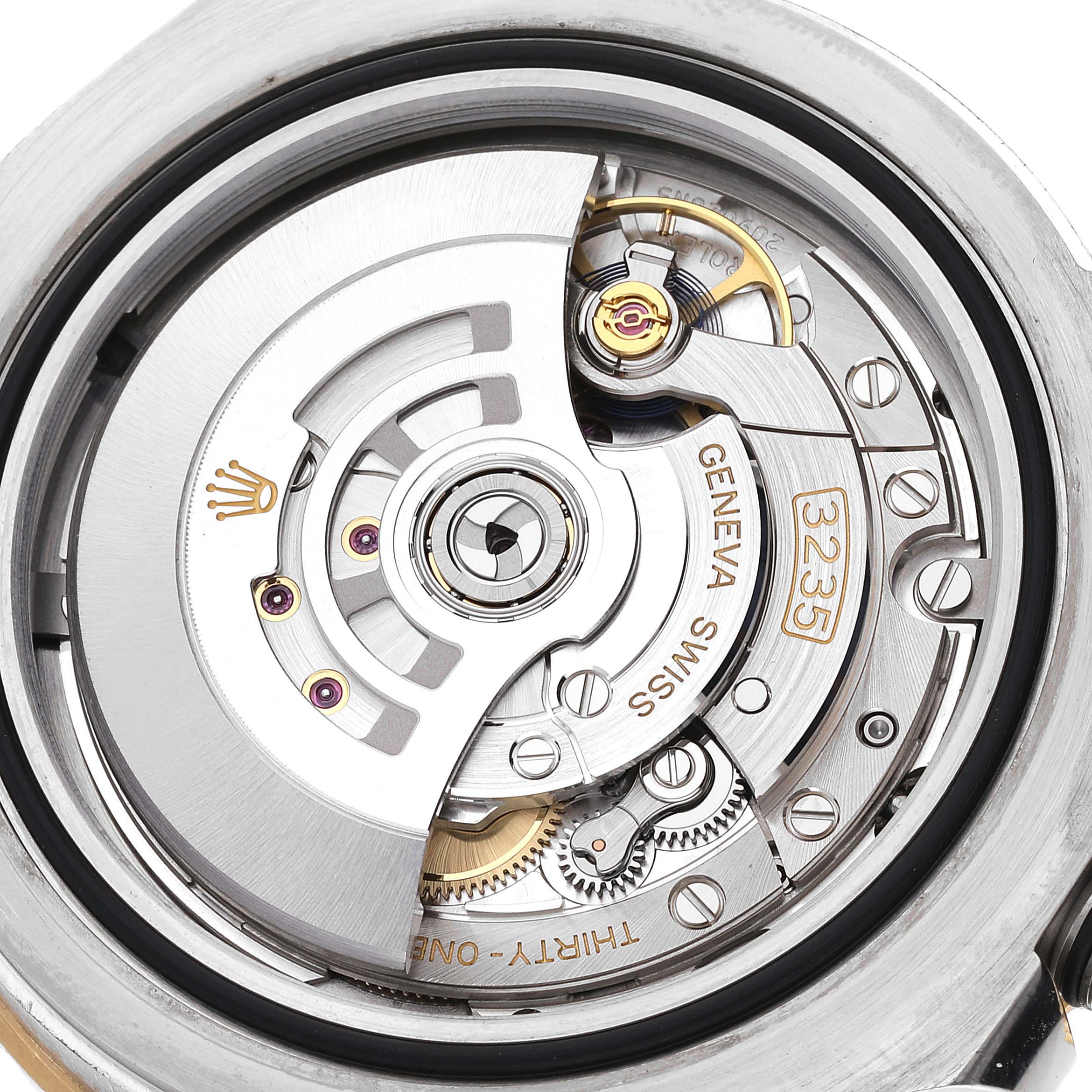 This image shows the intricate movement mechanism of the Rolex Sea-Dweller 126603 Men's Steel and Gold (two tone) Black Dial 126603 Men's Steel and Gold (two tone) Black Dial watch, highlighting gears, the rotor, and Swiss-made markings.