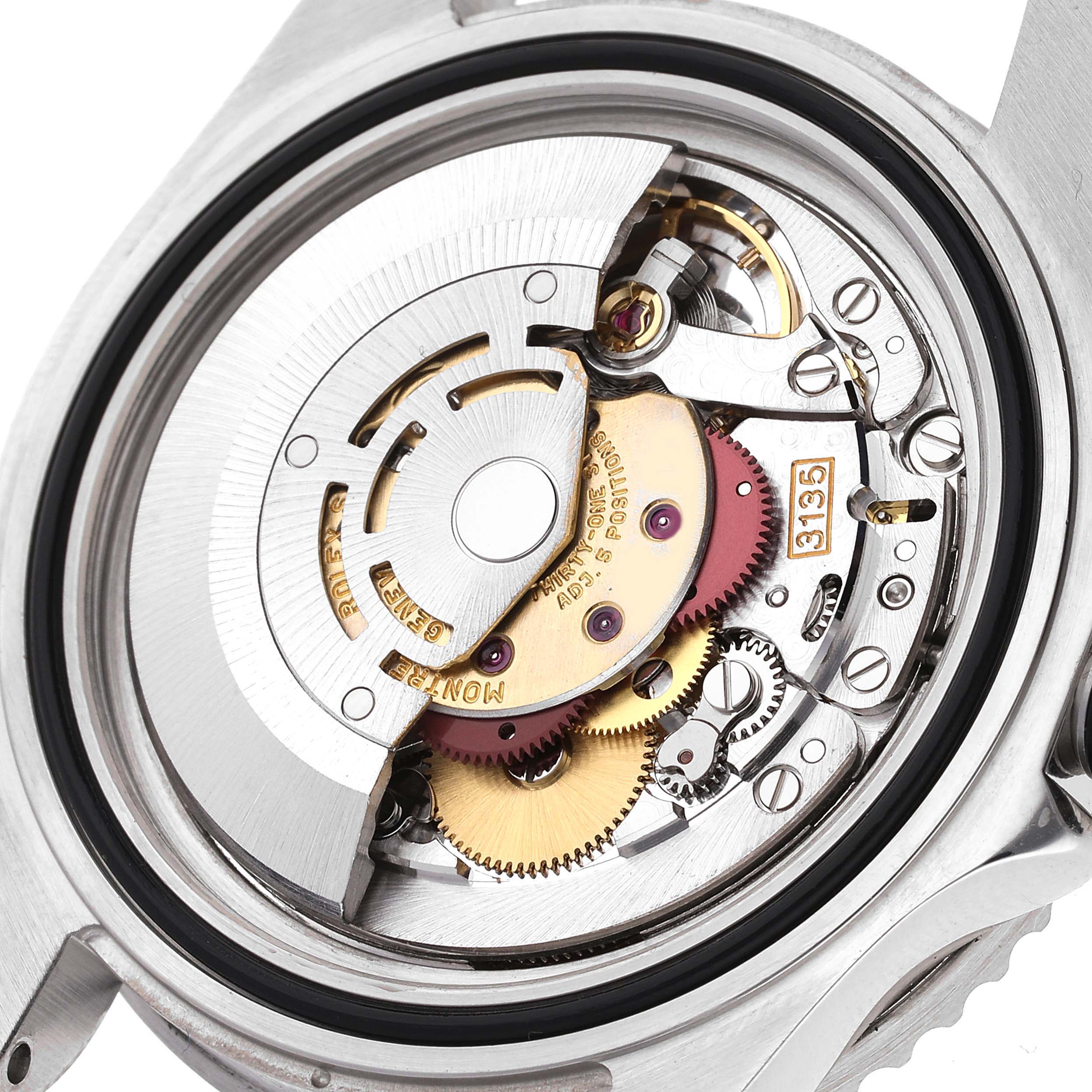 This image shows the internal mechanism of a Rolex Submariner 16610 Men
s Stainless Steel Black Dial 16610 Men
s Stainless Steel Black Dial watch from a back angle, highlighting gears and the rotor.