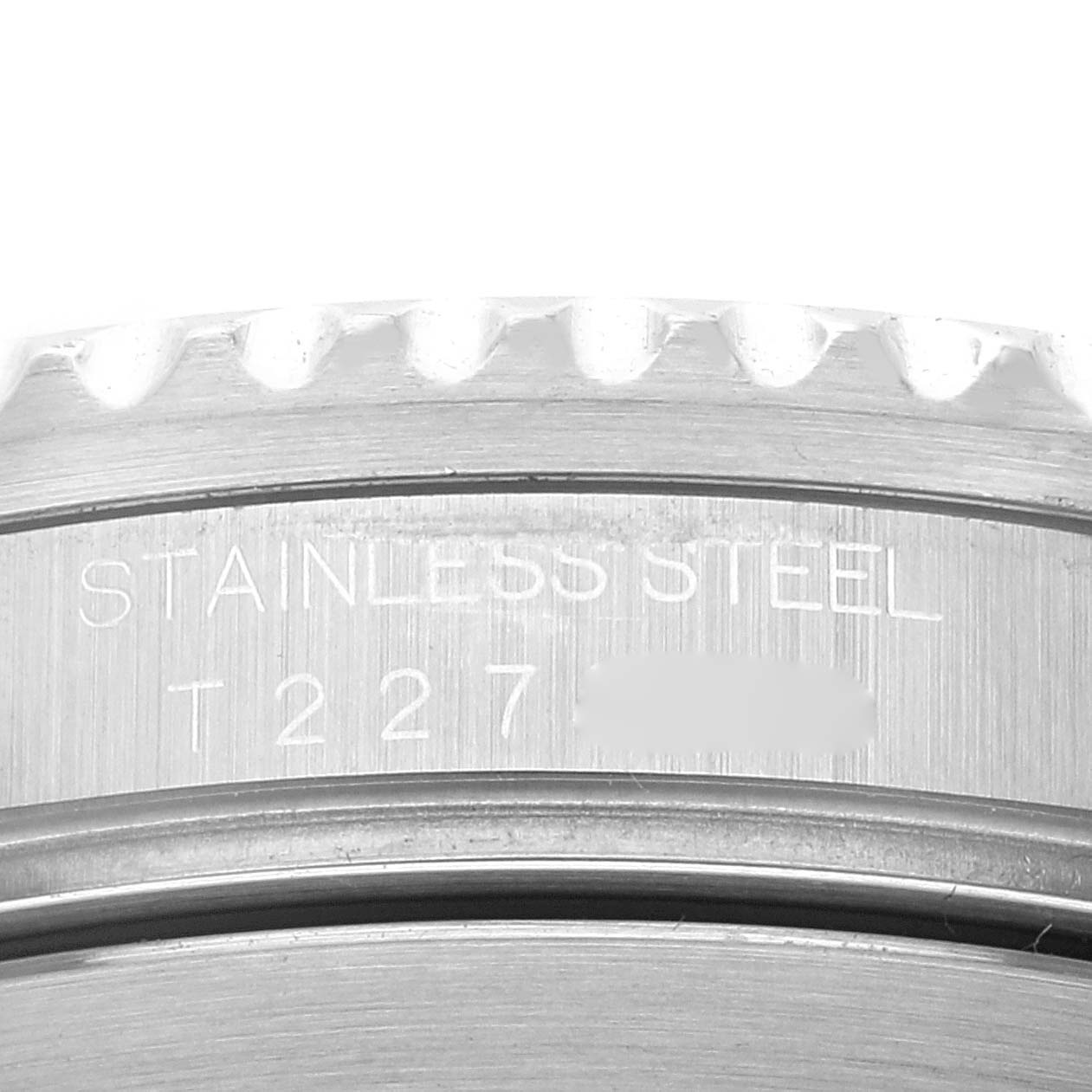 This close-up image shows part of the bezel and the engraved case of the Rolex Submariner 16610 Men
s Stainless Steel Black Dial 16610 Men
s Stainless Steel Black Dial watch in stainless steel.