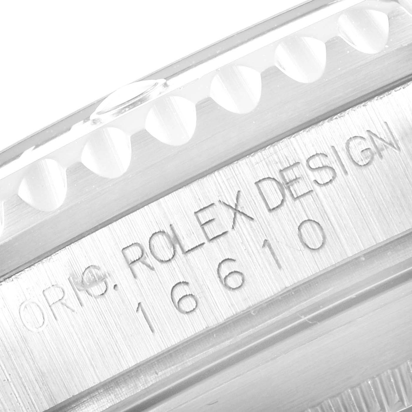 The image shows an angled close-up of the side of a Rolex Submariner 16610 Men
s Stainless Steel Black Dial 16610 Men
s Stainless Steel Black Dial model 16610, highlighting its bezel and model engraving.