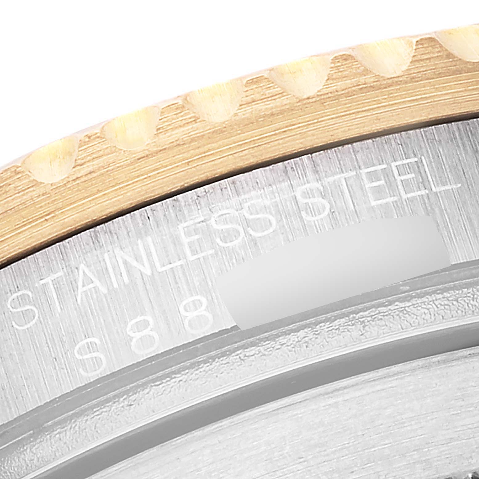 The image shows a close-up of the bezel and part of the case back of a Rolex Submariner 16613 Men's Steel and Gold (two tone) Champagne Dial 16613 Men's Steel and Gold (two tone) Champagne Dial watch.