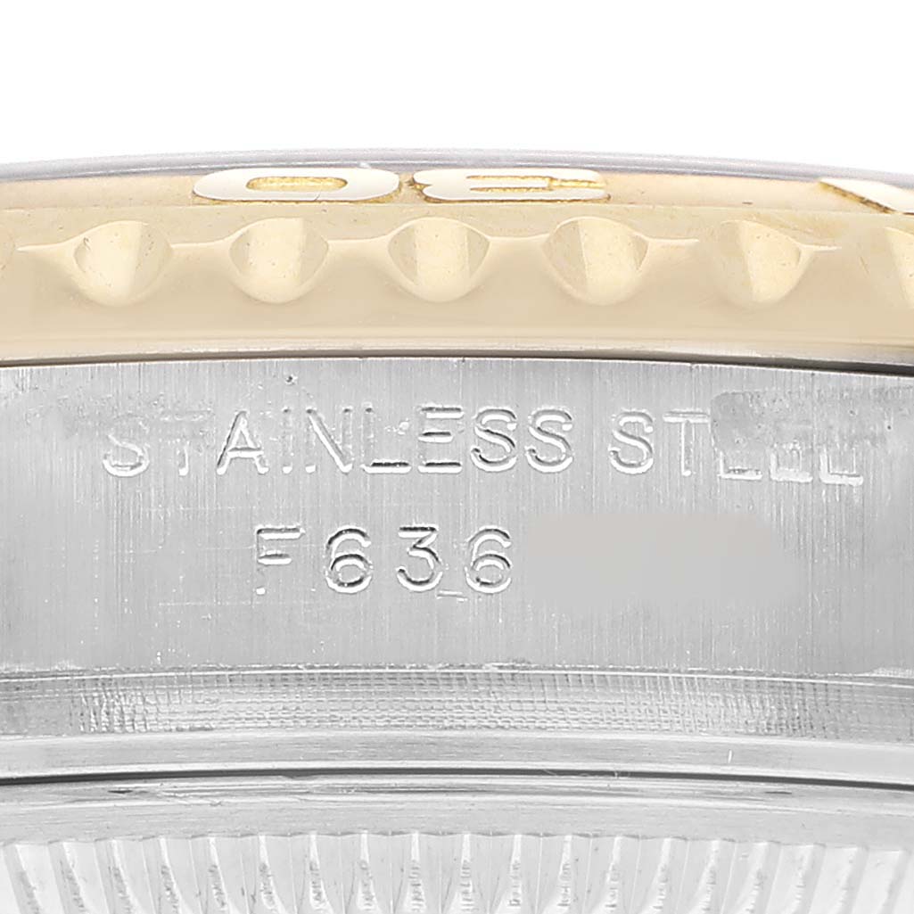 The image shows a close-up of the Rolex Yacht-Master 169623 Women's Steel and Gold (two tone) White Dial's bezel and part of the casing with "STAINLESS STEEL" engraved.