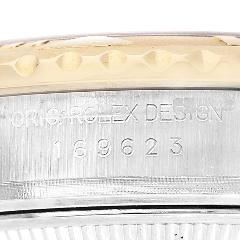 The image shows a close-up side view of a Rolex Yacht-Master 169623 Women's Steel and Gold (two tone) White Dial watch bezel and engraved model number.
