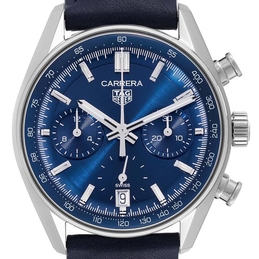 The TAG Heuer Carrera watch is shown from a frontal angle, highlighting the blue dial, subdials, crown, and pushers.