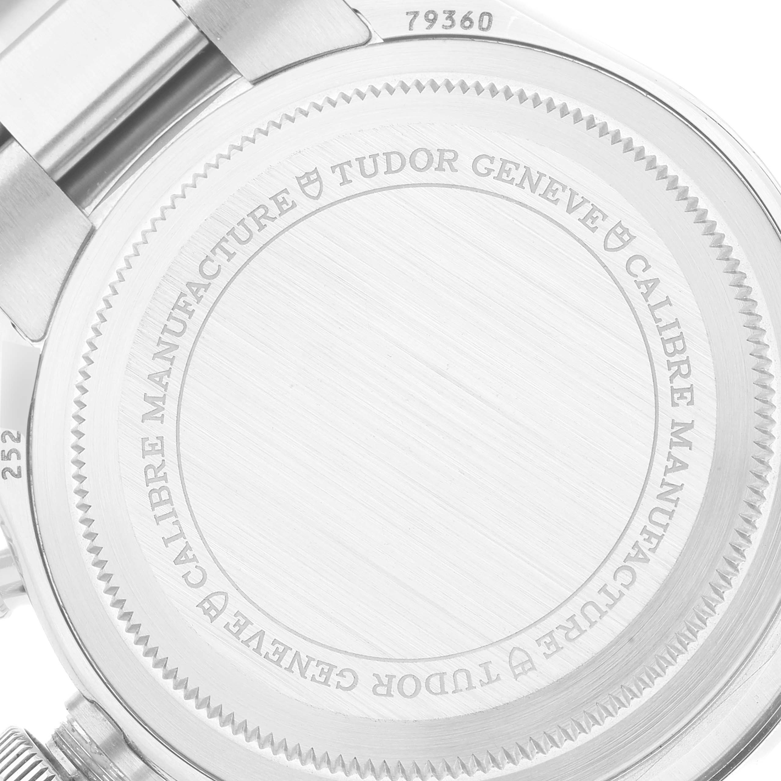 The image shows the back case of a Tudor Sport Chronograph watch, highlighting the etched brand and model details.