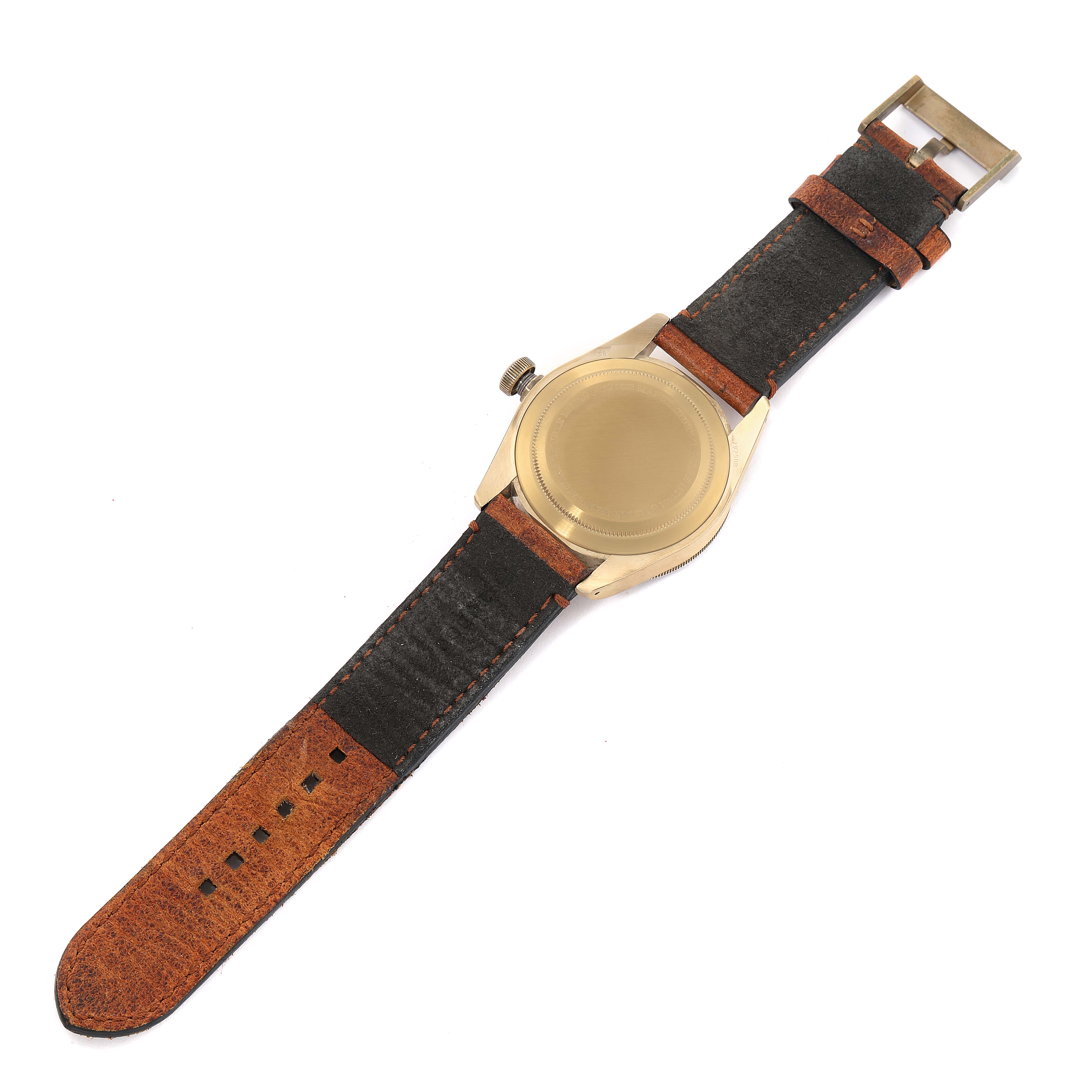 The Tudor Heritage Black Bay 79250B Men's Bronze Brown Dial 79250B Men's Bronze Brown Dial watch is shown from the back, displaying the case back, crown, and leather strap.