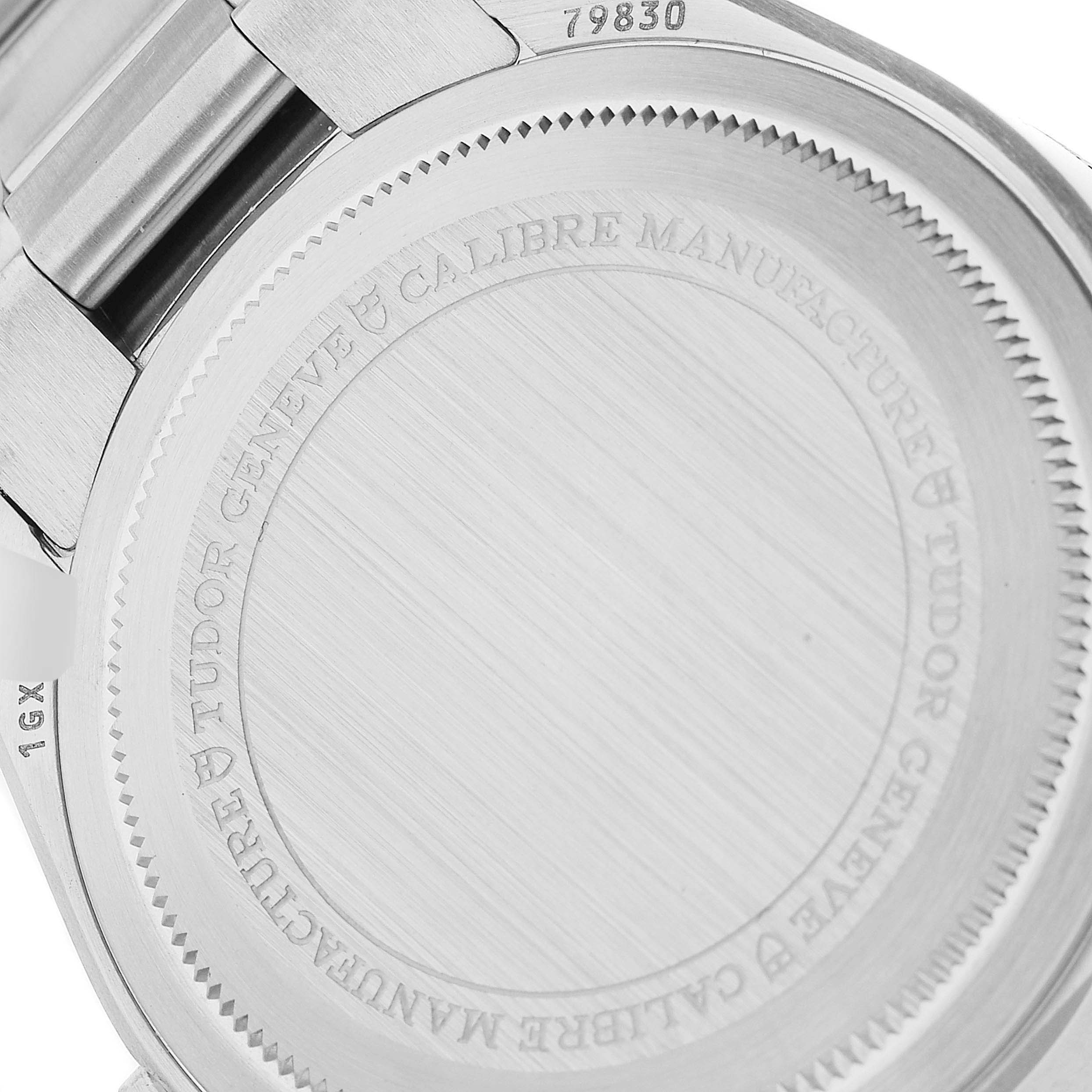 The image shows the case back of a Tudor Heritage Black Bay 79830RB Men
s Stainless Steel Black Dial 79830RB Men
s Stainless Steel Black Dial watch with engraved text detailing.