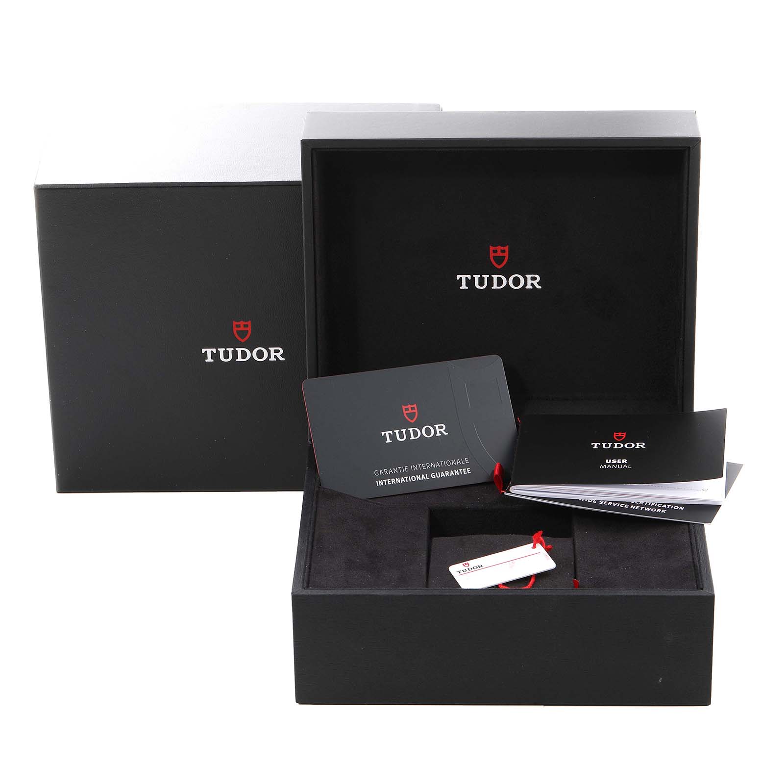 The image shows the Tudor Heritage Black Bay 79830RB Men
s Stainless Steel Black Dial 79830RB Men
s Stainless Steel Black Dial packaging, with the box, warranty card, user manual, and tags.