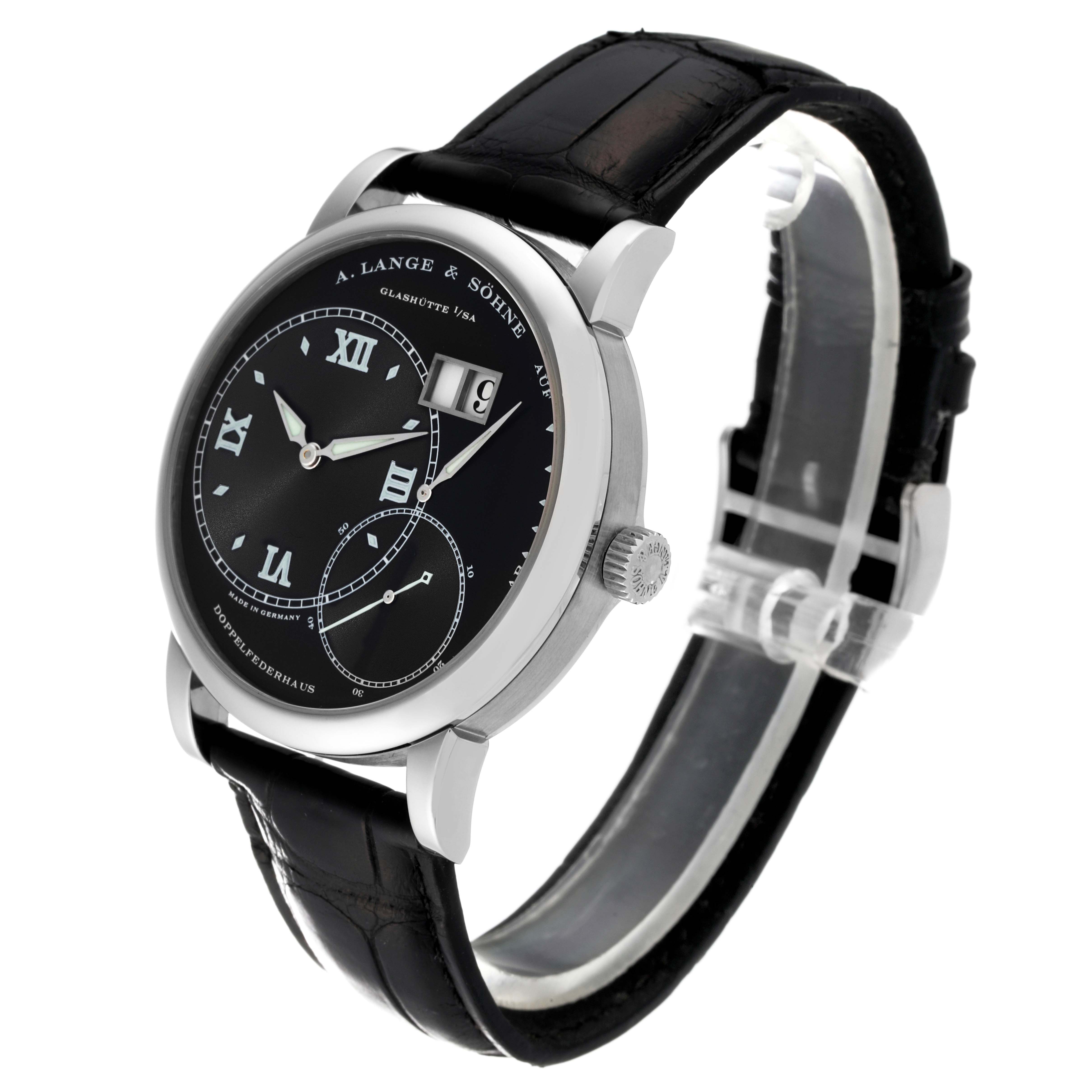 The image shows a side angle of an A. Lange & Sohne Lange 1 115.028 Men's White Gold Black Dial watch, displaying the dial, crown, and black leather strap.