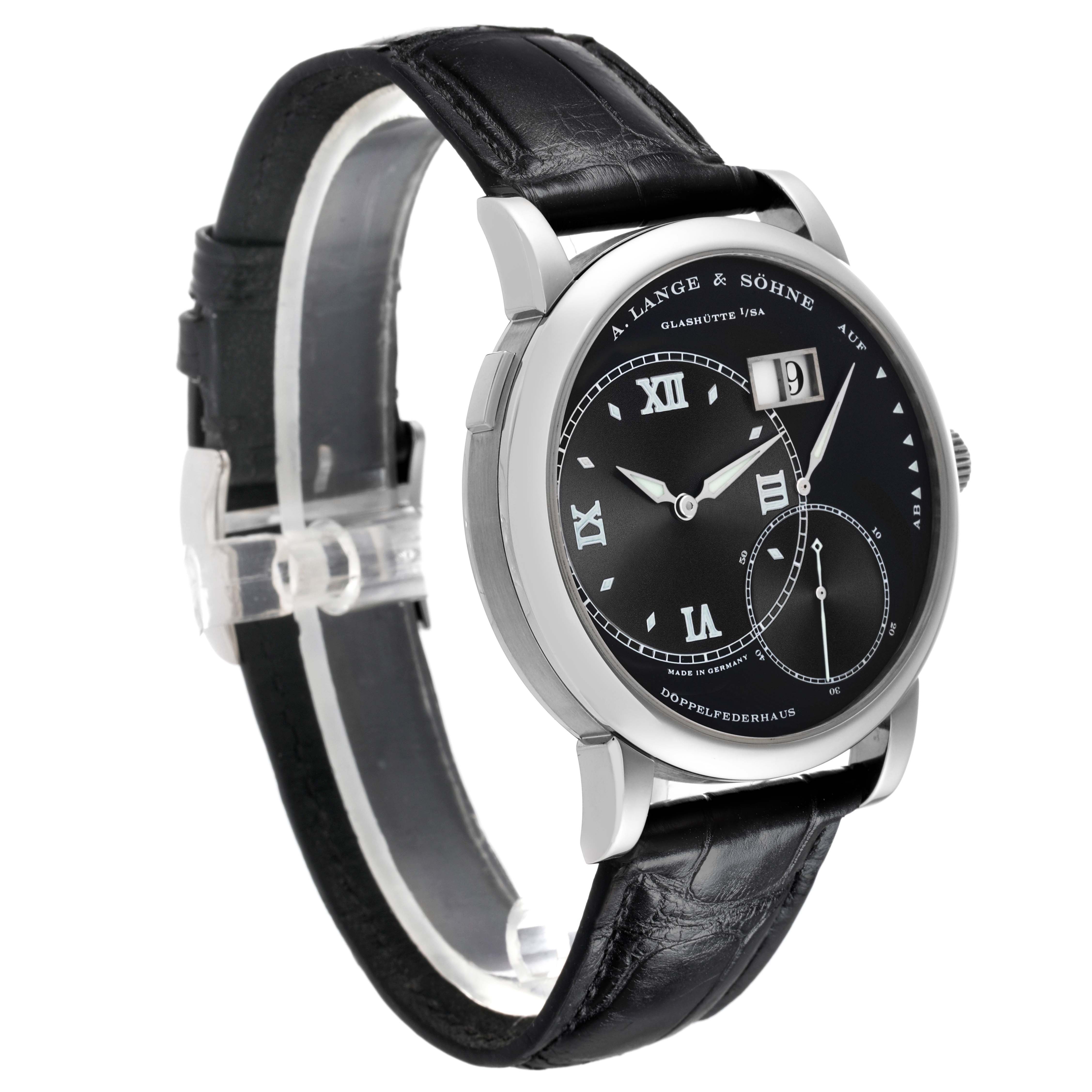 The Lange 1 by A. Lange & Söhne is shown at a three-quarter angle, highlighting the black dial, Roman numerals, and leather strap.