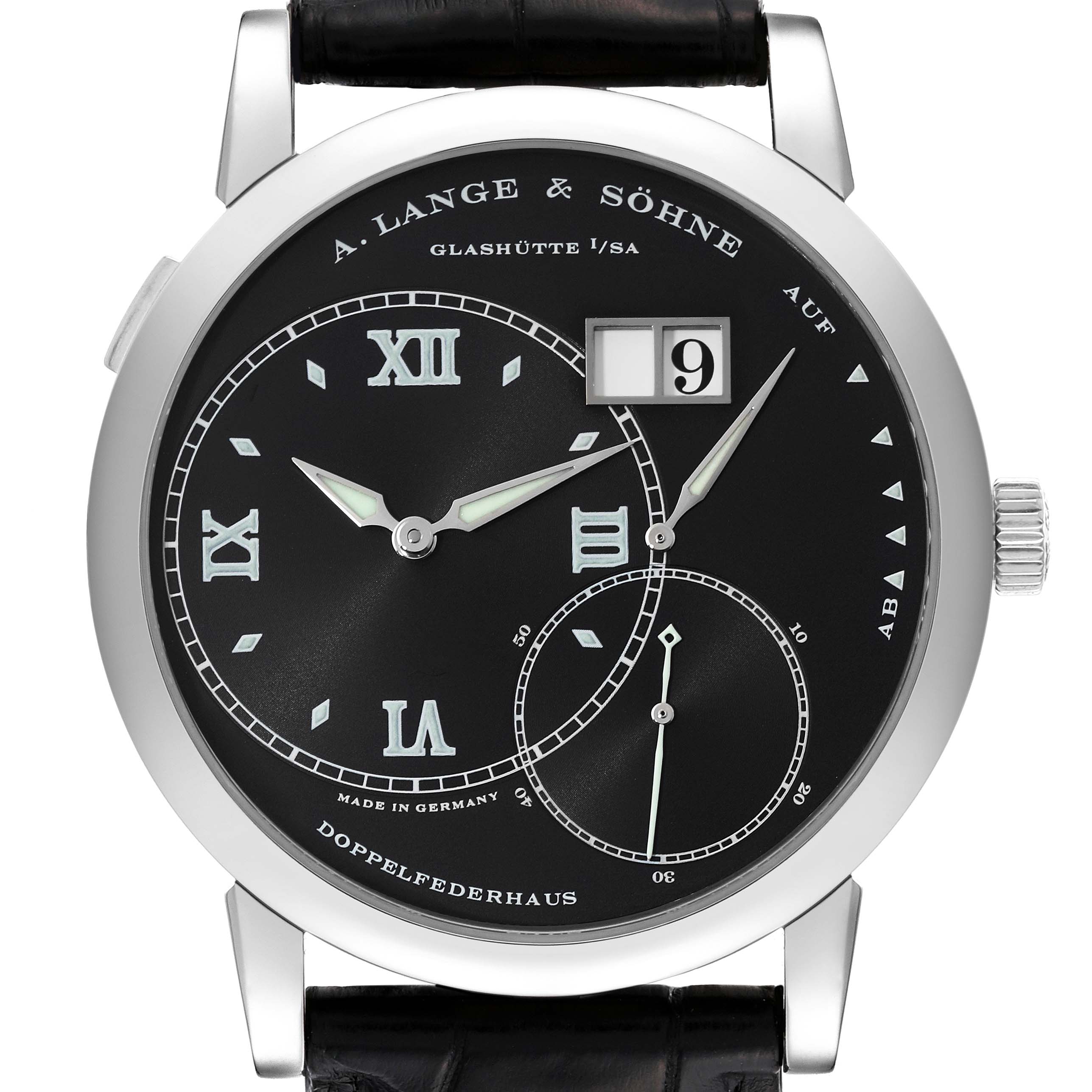 The image shows the face of an A. Lange & Sohne Lange 1 115.028 Men's White Gold Black Dial watch, displaying its dial, hands, date window, and strap in a front angle.