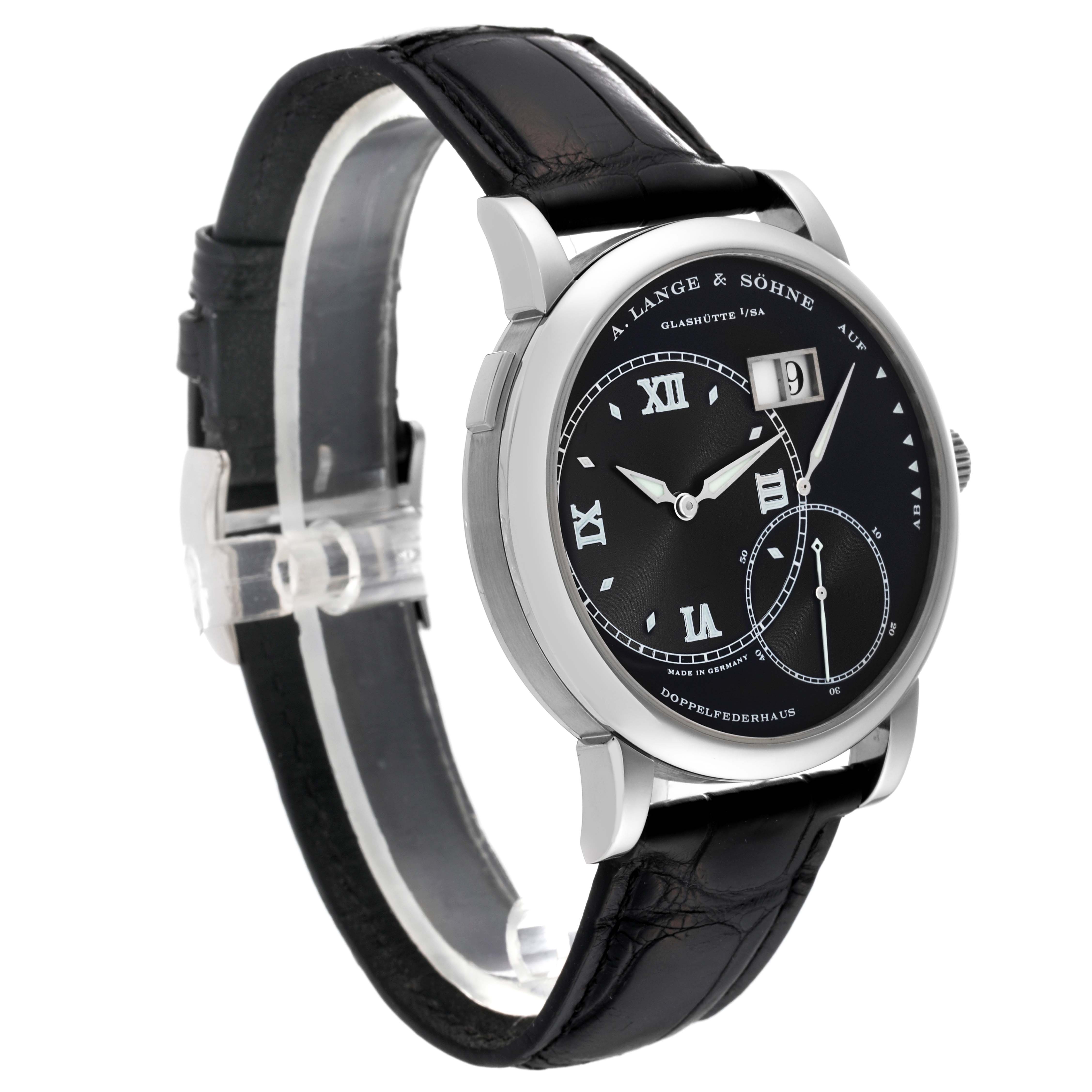 The image shows a side angle of the A. Lange & Sohne Lange 1 model, featuring its black dial, leather strap, and date display.