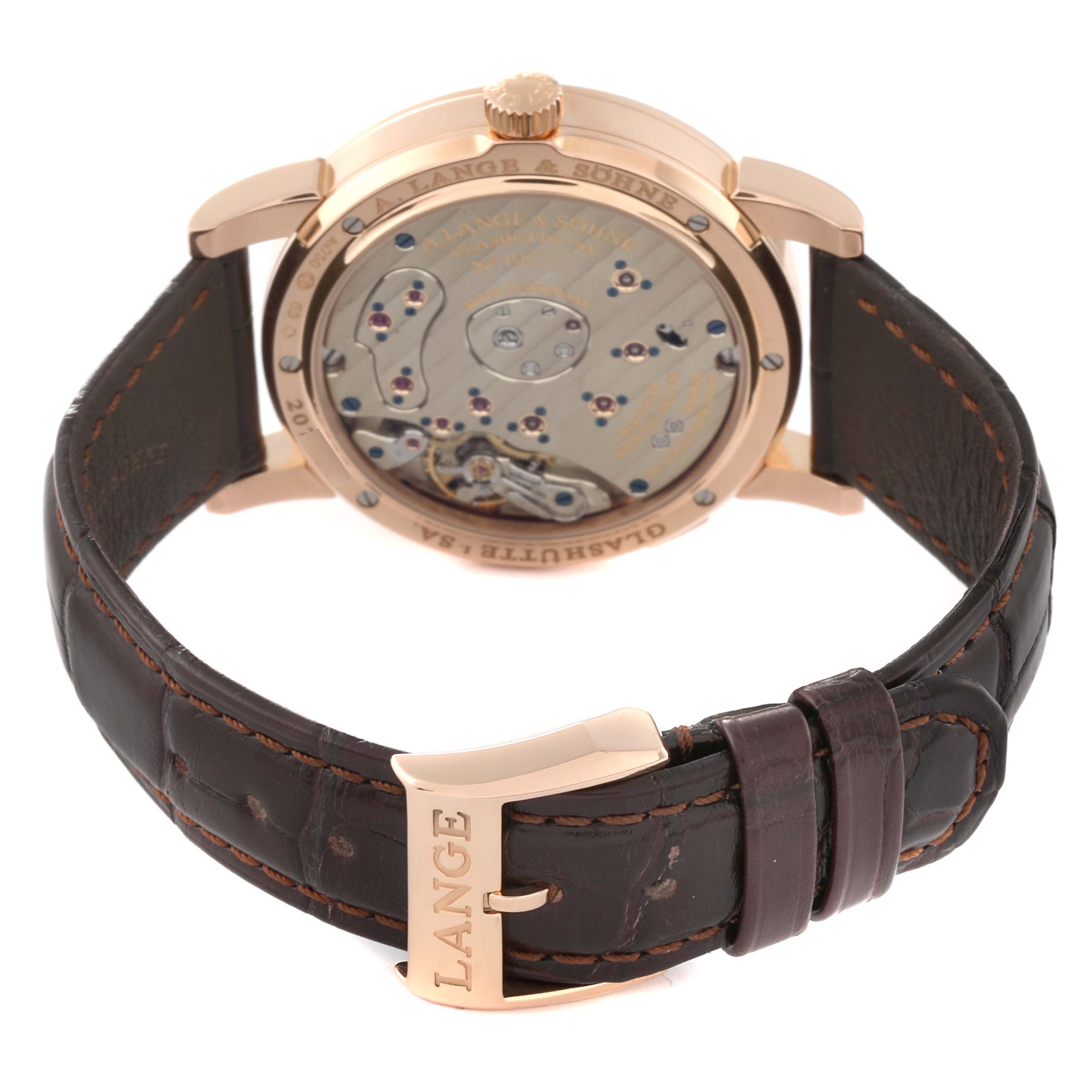 The Lange 1 model by A. Lange & Söhne is shown from the back, displaying the movement and parts of the leather strap with buckle.