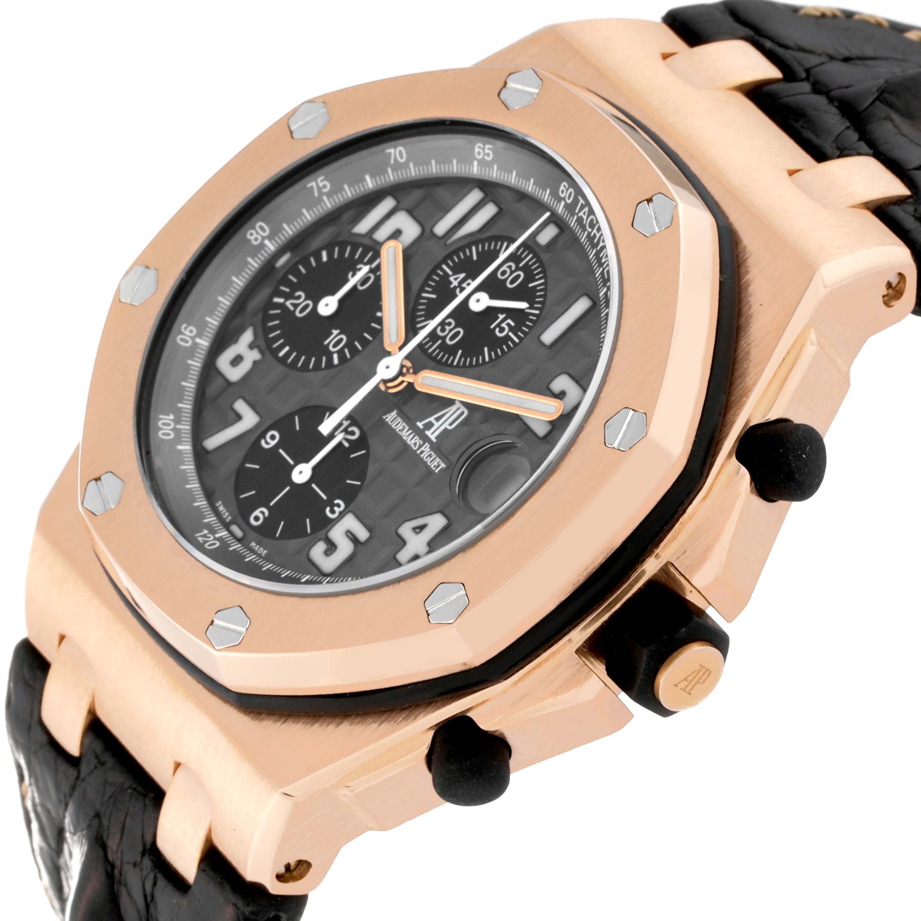 This Royal Oak Offshore by Audemars Piguet is shown at an angled close-up, highlighting its rose gold case, black dial, and leather strap.