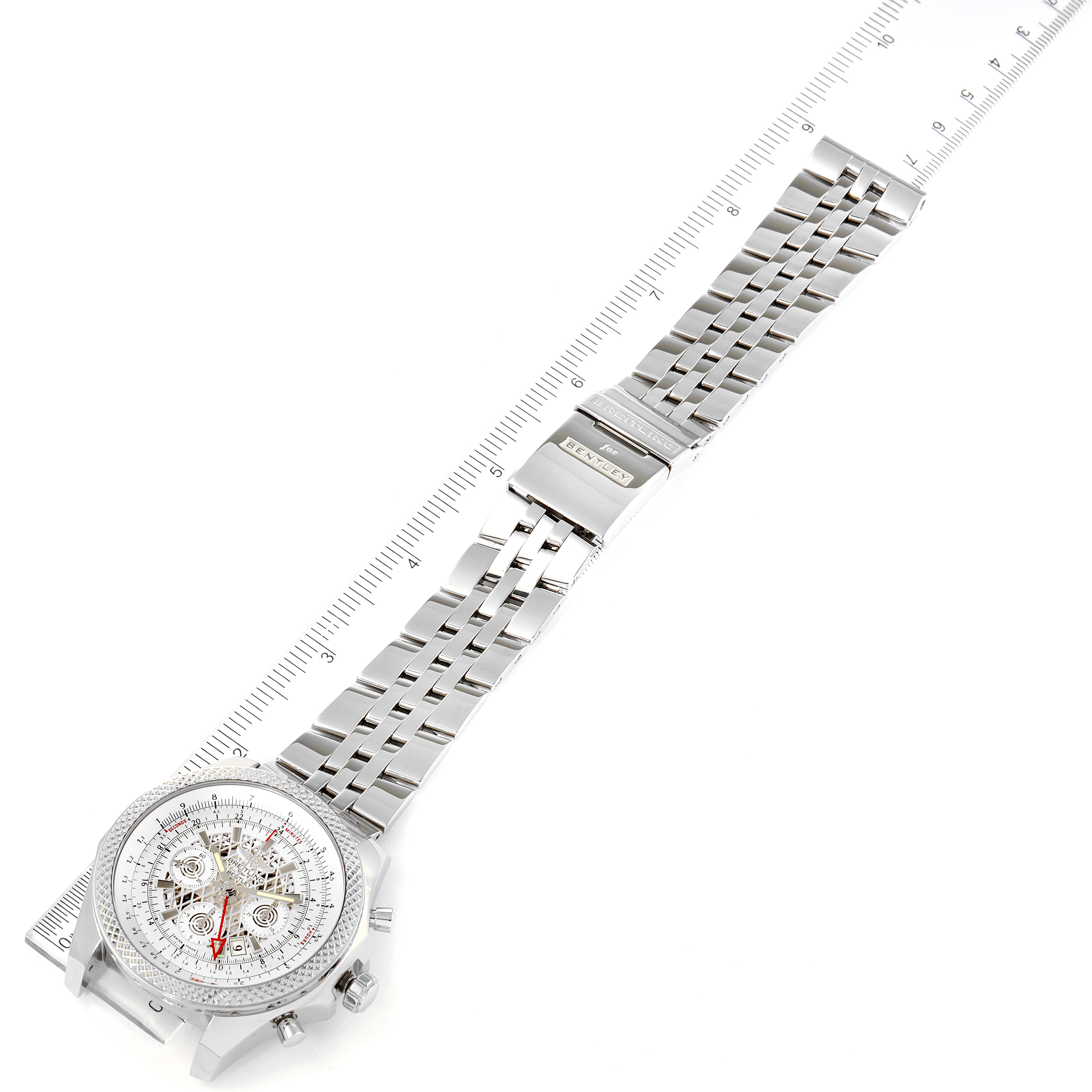 The image shows a Bentley model by Breitling, viewed at a top-down angle, displaying its full bracelet and dial with a ruler measuring its length.