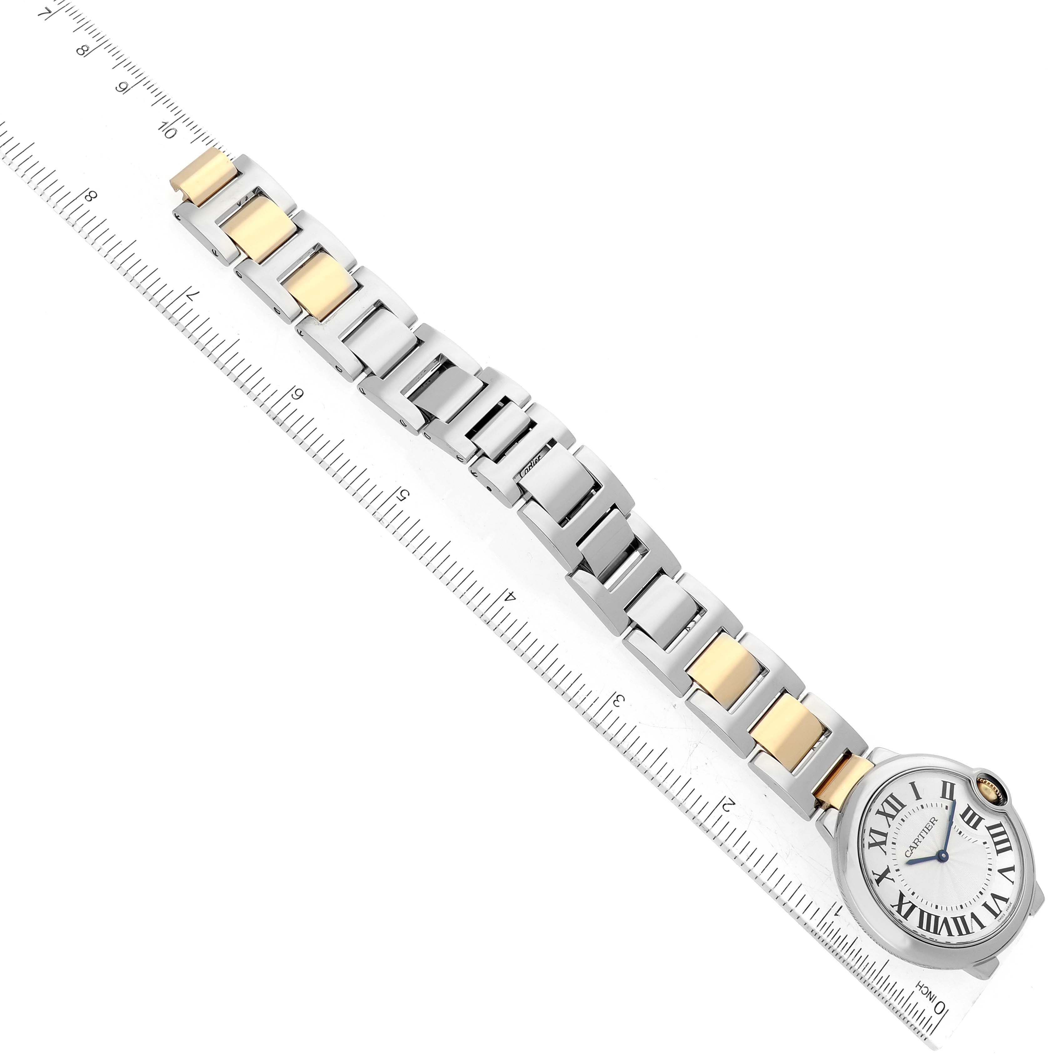 The image shows a Ballon Bleu model watch by Cartier, displayed along a ruler to measure its bracelet length.