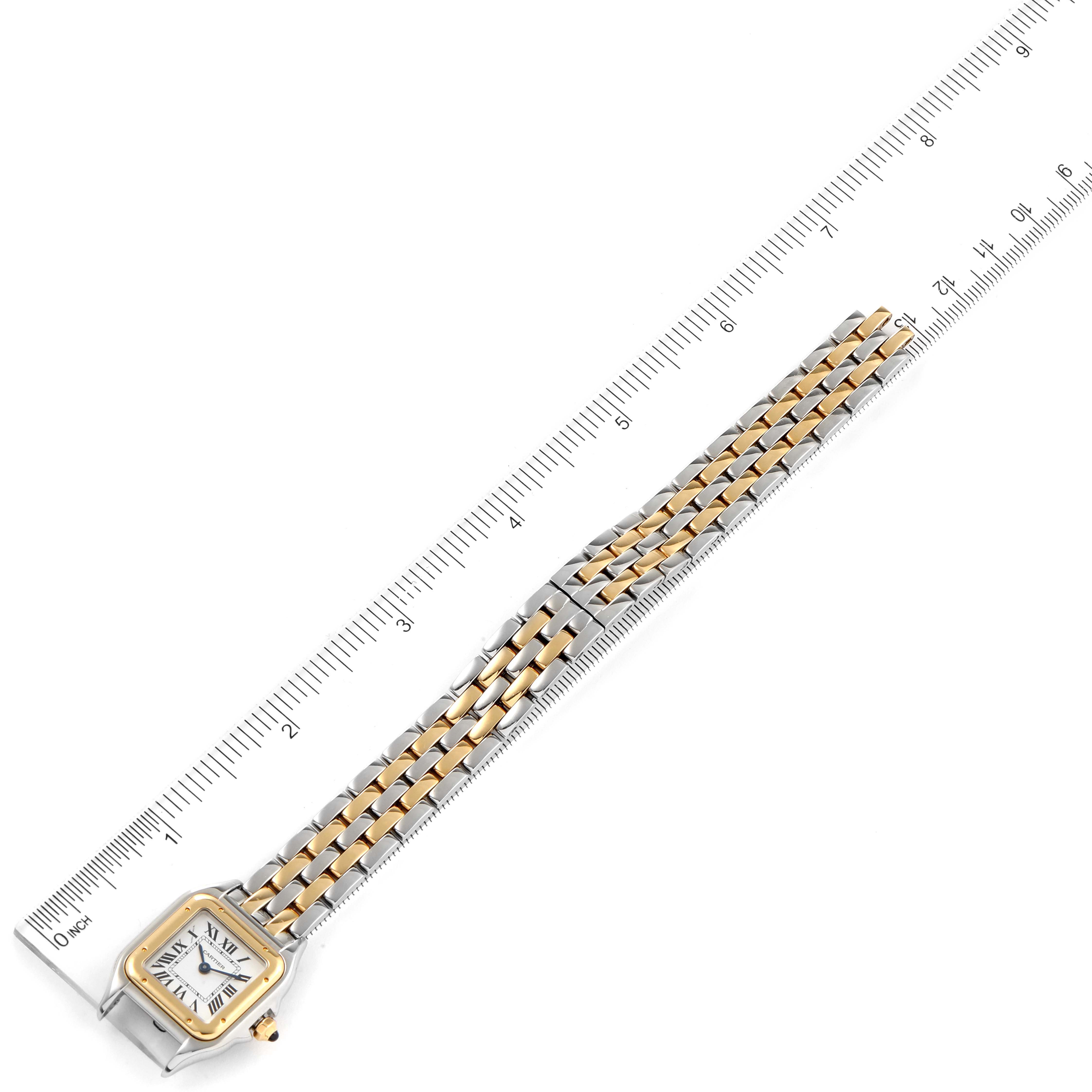 This image shows a top-down view of a Cartier Panthere W2PN0006 Women's Steel and Gold (two tone) Silver Dial W2PN0006 Women's Steel and Gold (two tone) Silver Dial watch laid out beside a ruler.