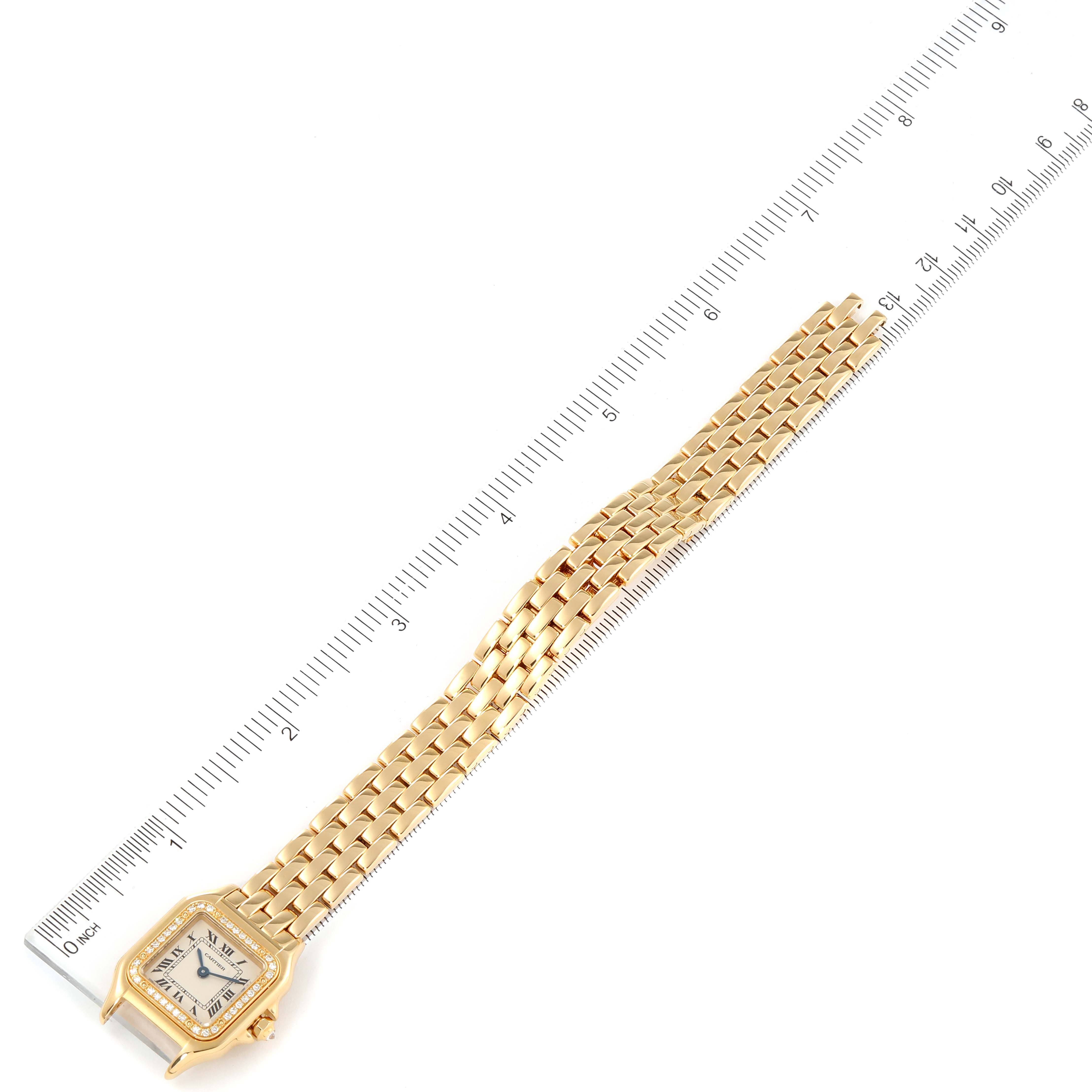 This image shows a top-down view of a Cartier Panthere WJPN0015 Women's Yellow Gold Silver Dial WJPN0015 Women's Yellow Gold Silver Dial watch, highlighting the face, bracelet, and a ruler for scale.