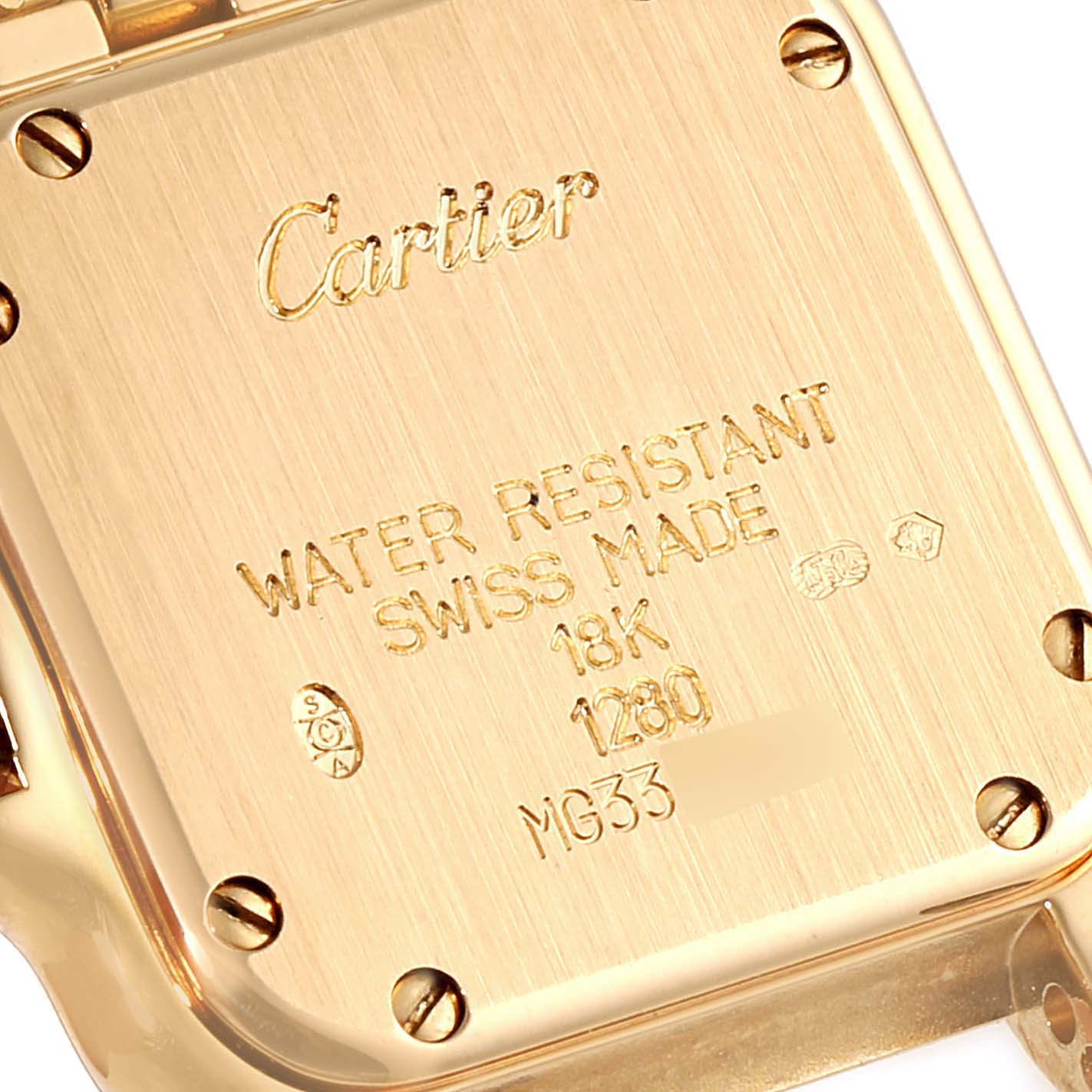 This image shows the case back of a Cartier Panthere WJPN0015 Women's Yellow Gold Silver Dial WJPN0015 Women's Yellow Gold Silver Dial watch, highlighting its engravings and screws.
