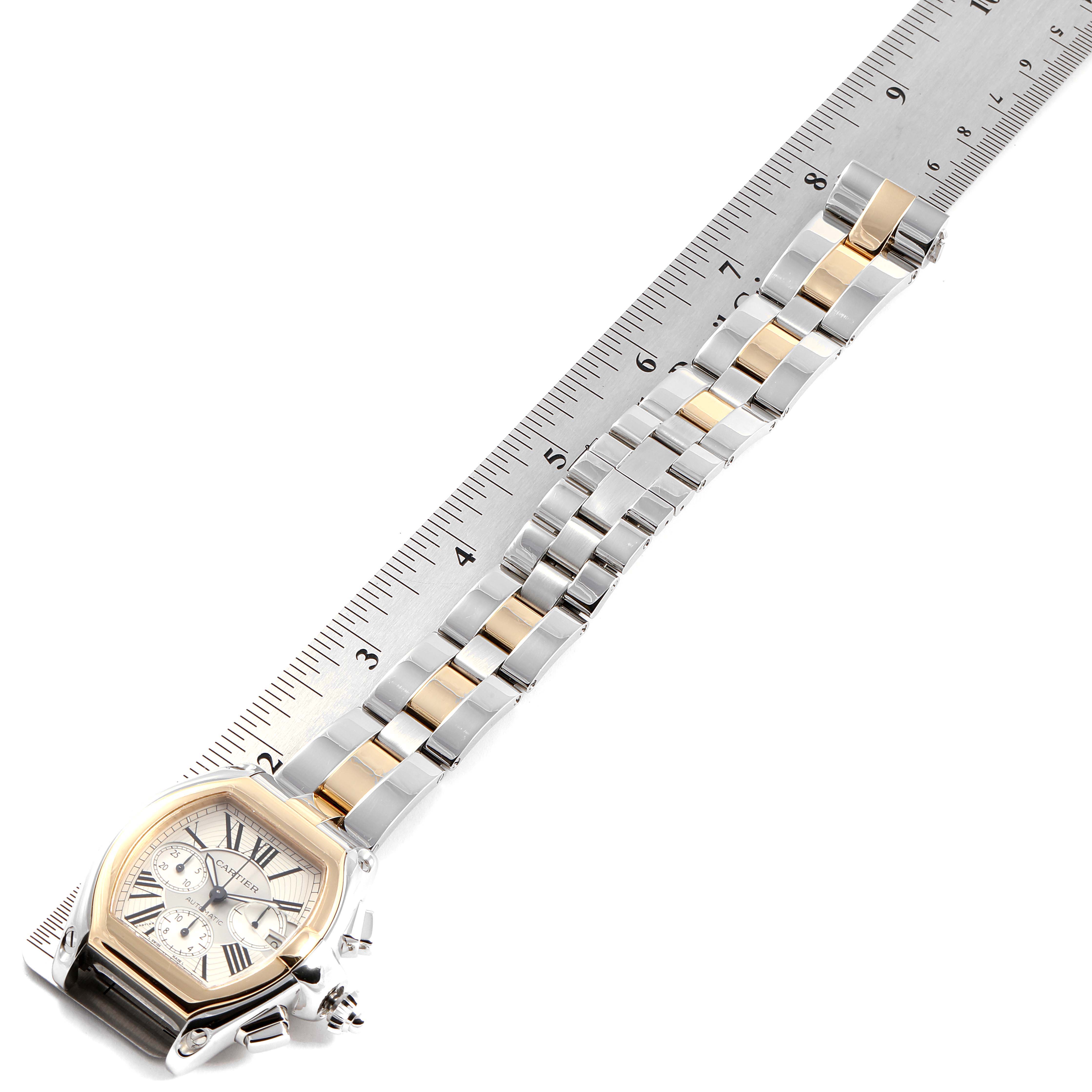 The Cartier Roadster W62027Z1 Men
s Steel and Gold (two tone) Silver Dial W62027Z1 Men
s Steel and Gold (two tone) Silver Dial watch is shown from an angle that captures the face and the full bracelet next to a ruler for size reference.