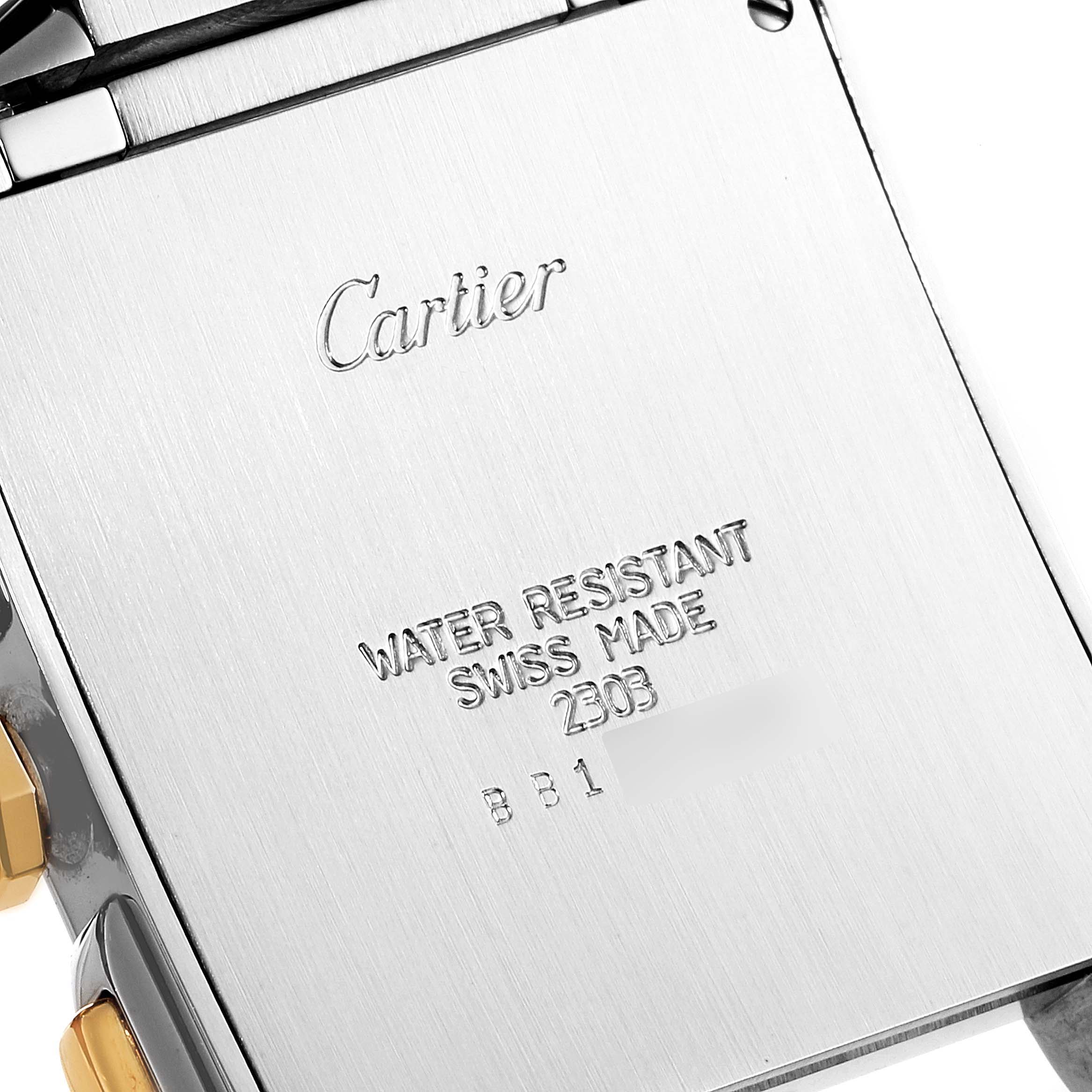 This image shows the back casing of a Cartier Tank Francaise W51004Q4 Men's Steel and Gold (two tone) Silver Dial W51004Q4 Men's Steel and Gold (two tone) Silver Dial watch, featuring engraved branding and specifications.