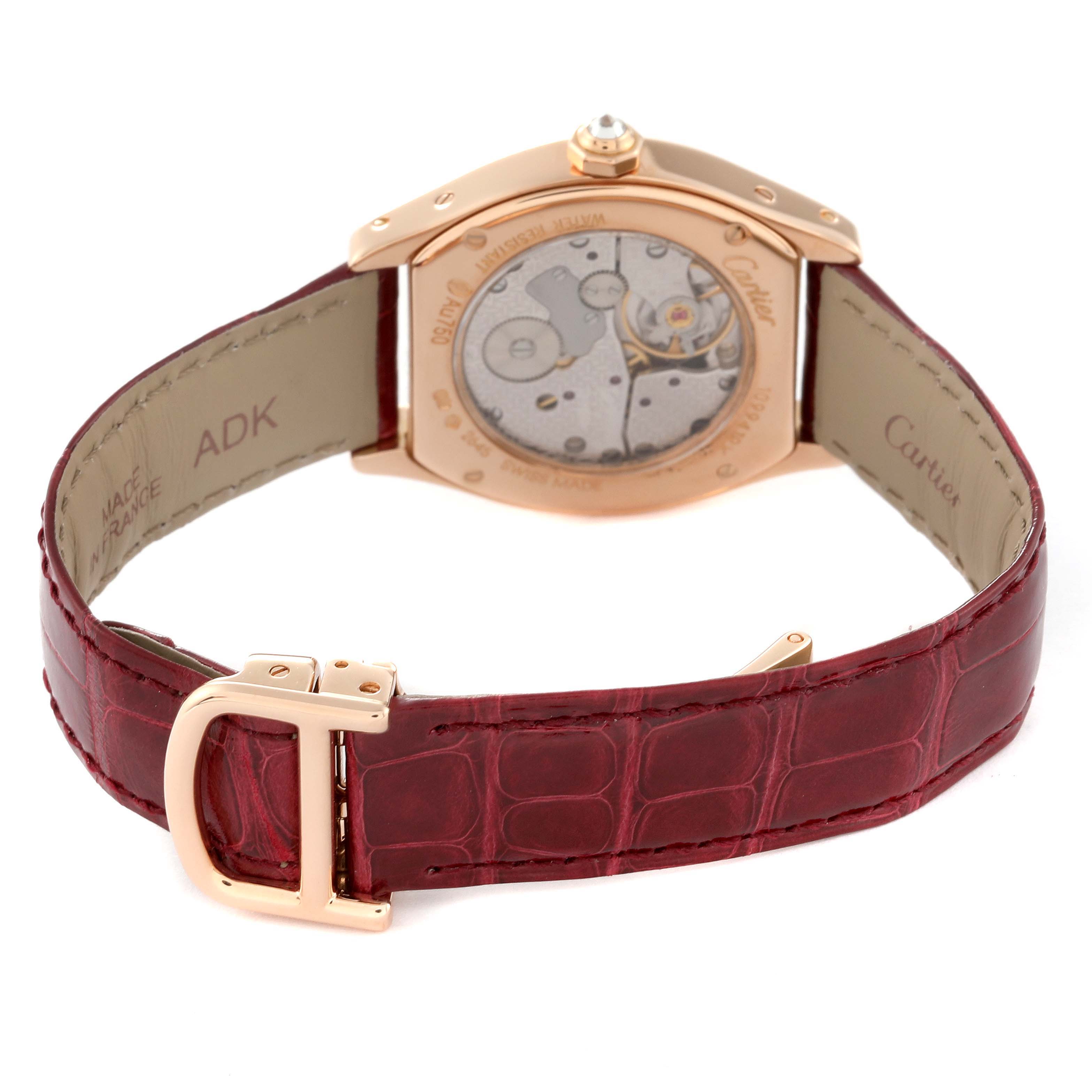 The image shows the back view of a Cartier Tortue WA507031 Women
s Rose Gold Silver Dial WA507031 Women
s Rose Gold Silver Dial watch, highlighting its movement and red leather strap.