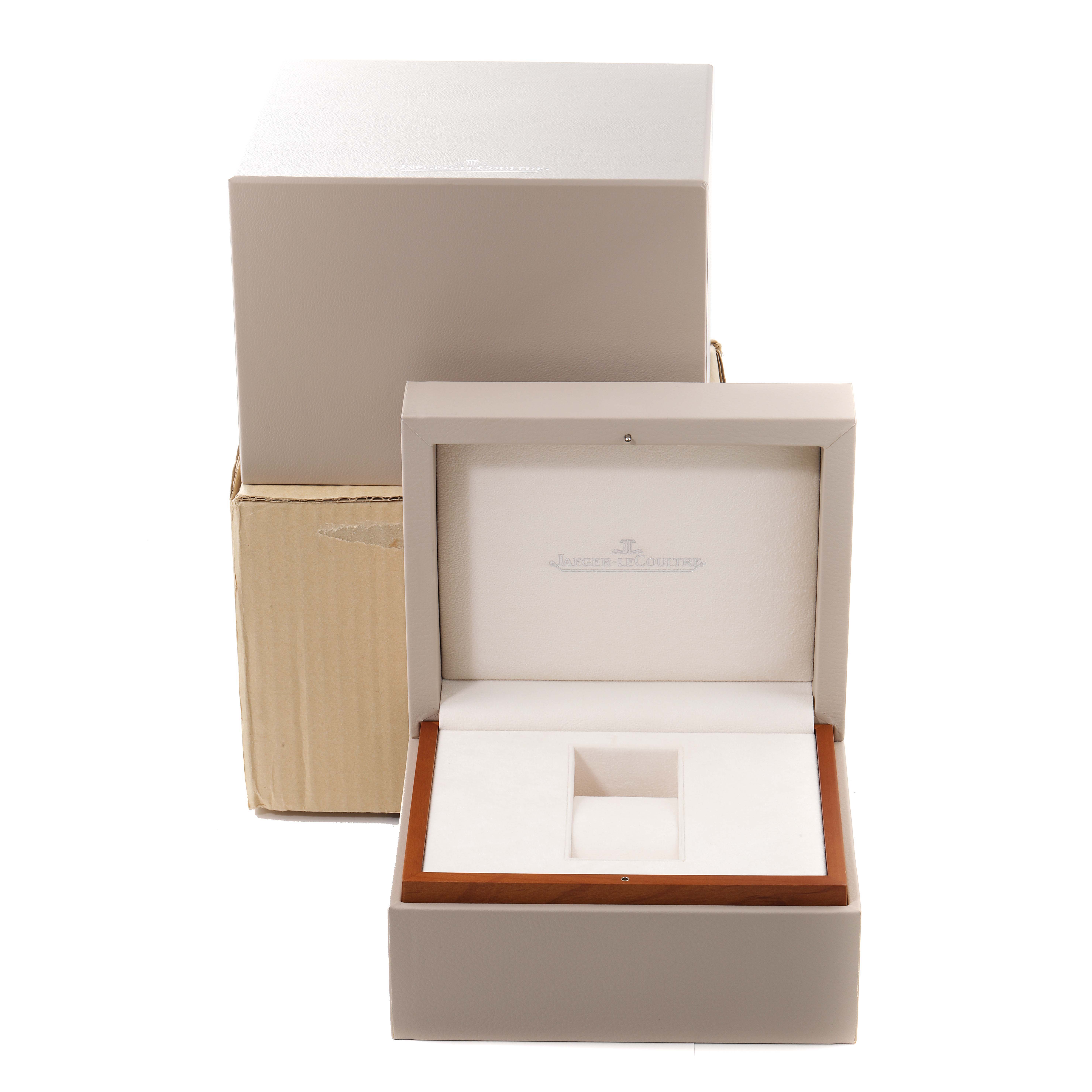 The image shows open packaging and a presentation box for a Jaeger-LeCoultre Reverso watch, viewed from the front.