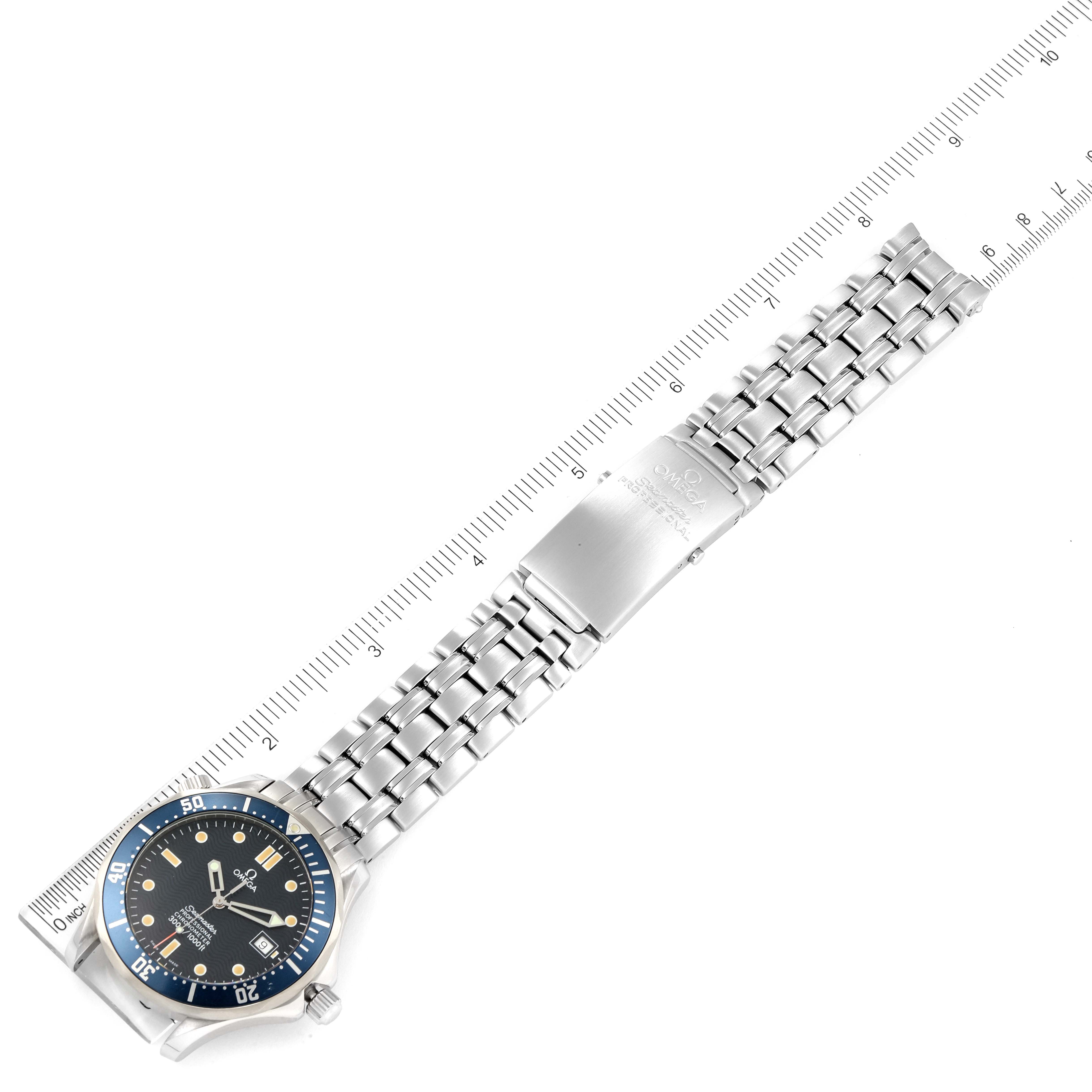 The image shows the Omega Seamaster 2531.80.00 Men's Stainless Steel Blue Dial 2531.80.00 Men's Stainless Steel Blue Dial watch and its stainless steel bracelet laid flat next to a ruler for measurement.
