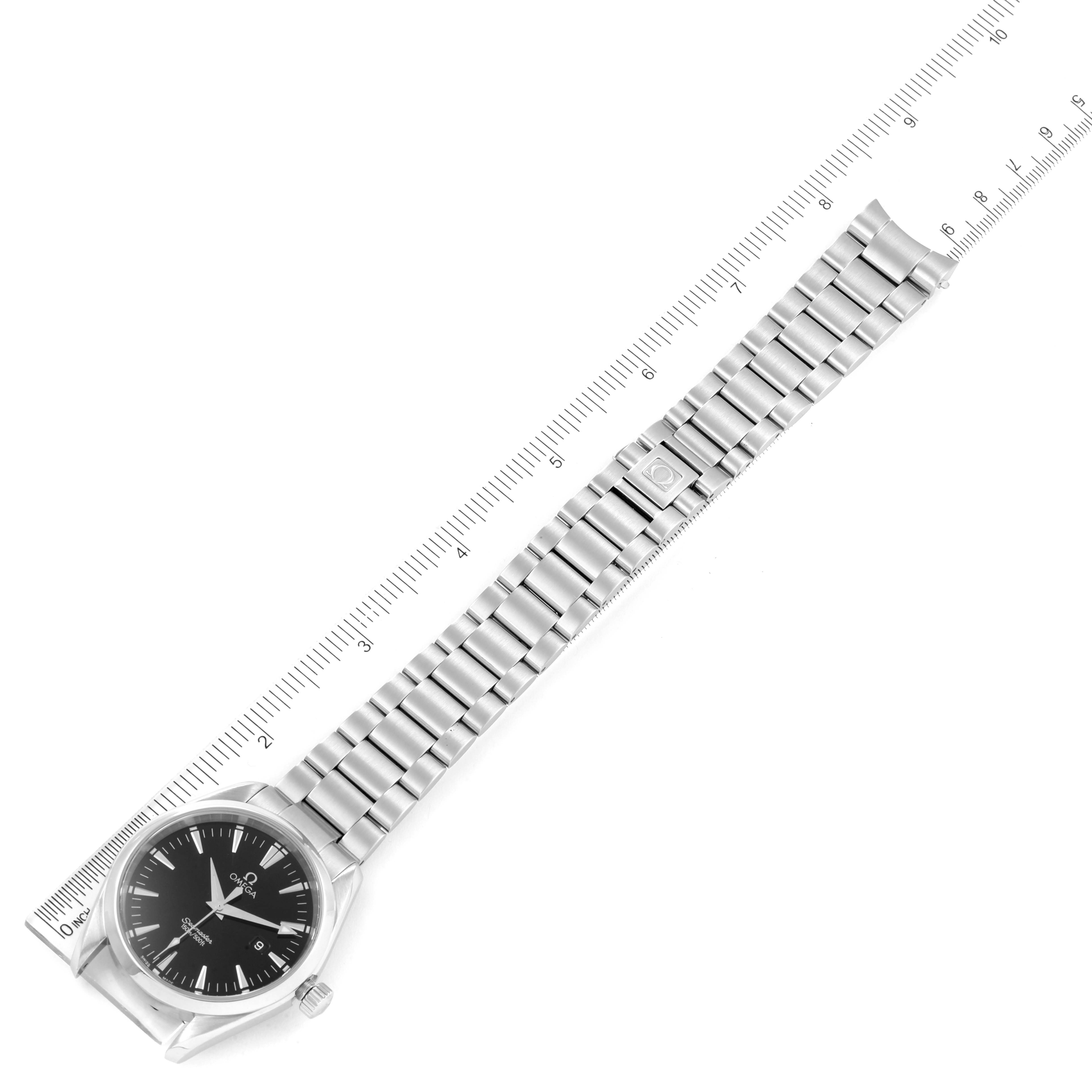 The Omega Aqua Terra 2517.50.00 Men's Stainless Steel Black Dial 2517.50.00 Men's Stainless Steel Black Dial watch is shown horizontally, displaying the entire watch including the face, bezel, crown, and metal bracelet next to a ruler.