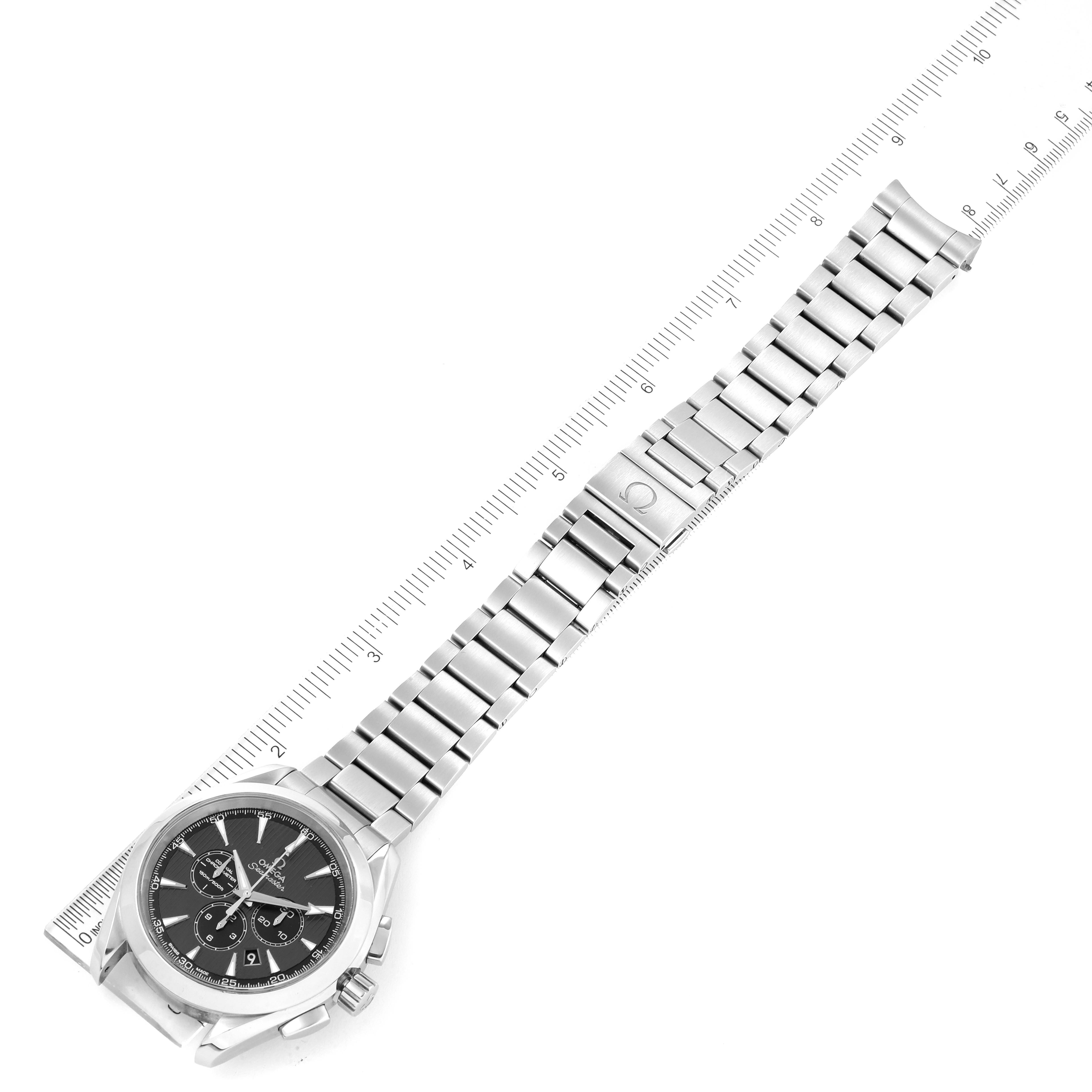 The Omega Aqua Terra 231.10.44.50.06.001 Men's Stainless Steel Black Dial 231.10.44.50.06.001 Men's Stainless Steel Black Dial watch is shown in a flat lay, displaying its face and metal bracelet alongside a ruler.