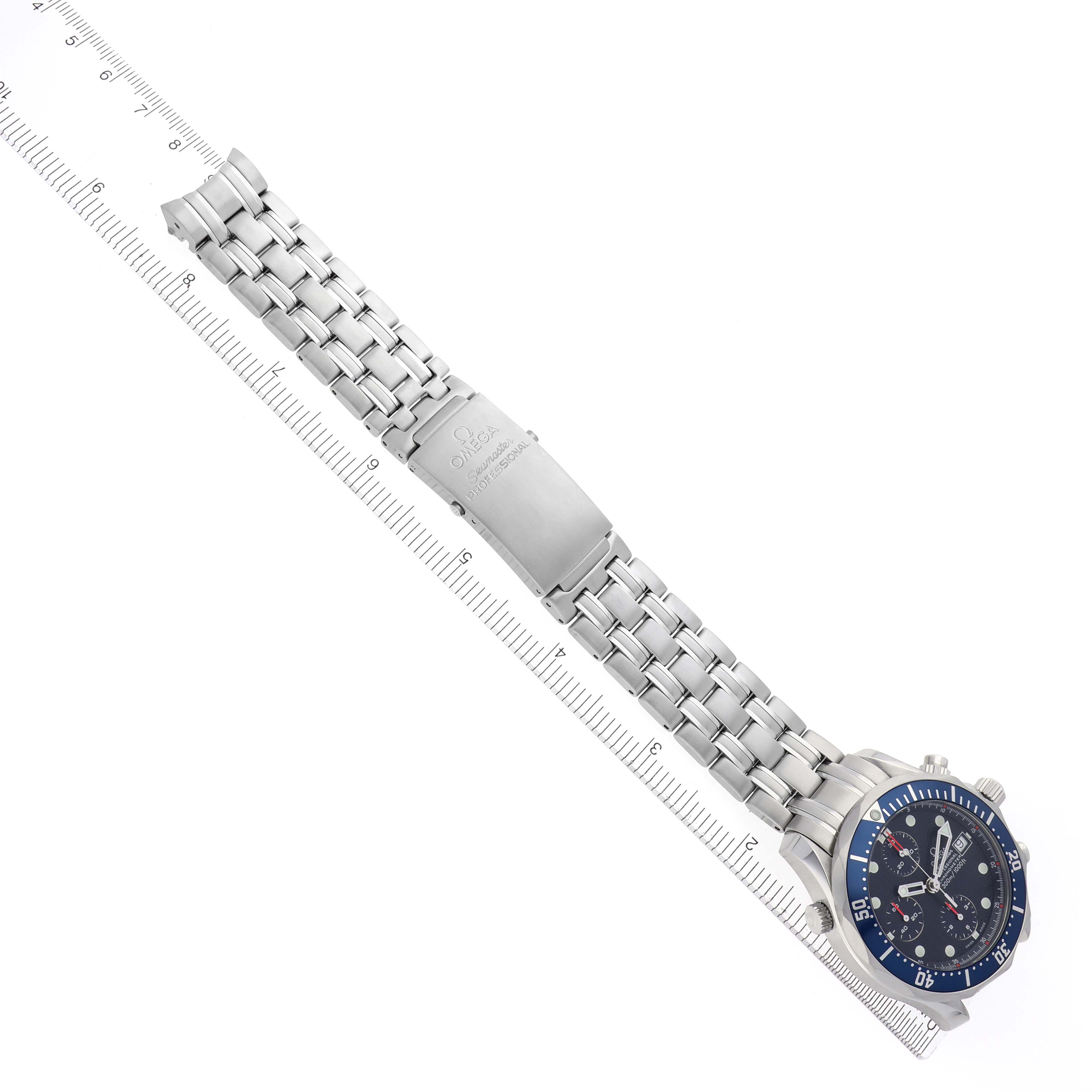 The Omega Seamaster 2599.80.00 Men's Stainless Steel Blue Dial 2599.80.00 Men's Stainless Steel Blue Dial watch is shown at a diagonal angle, displaying the face, bracelet, and clasp alongside a ruler for scale.