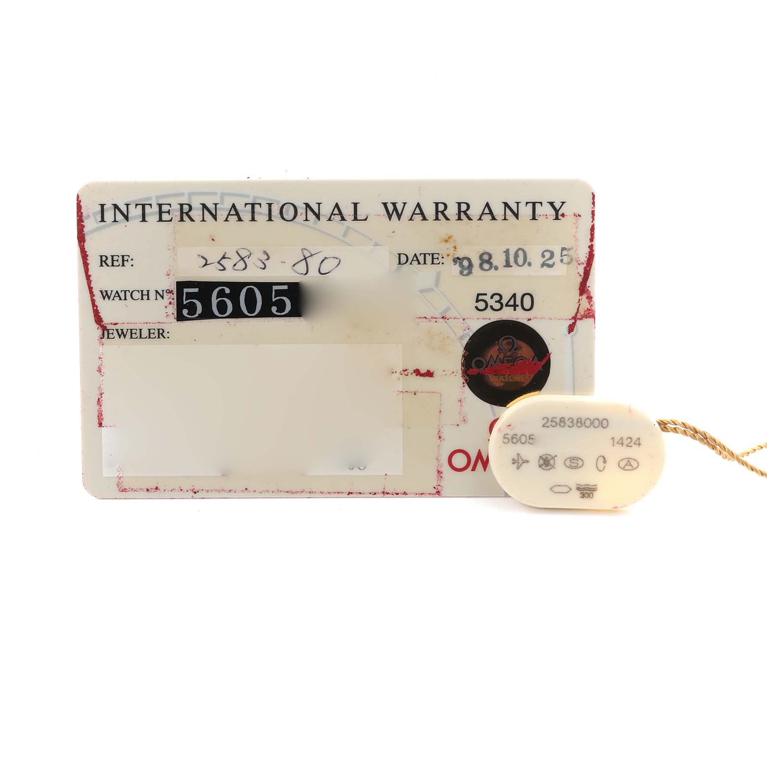 The image shows the international warranty card and tag for an Omega 2583.80.00 Women's Stainless Steel Blue Dial 2583.80.00 Women's Stainless Steel Blue Dial Seamaster Diver 300M 28mm Steel Ladies Watch, model 2583.80.00.