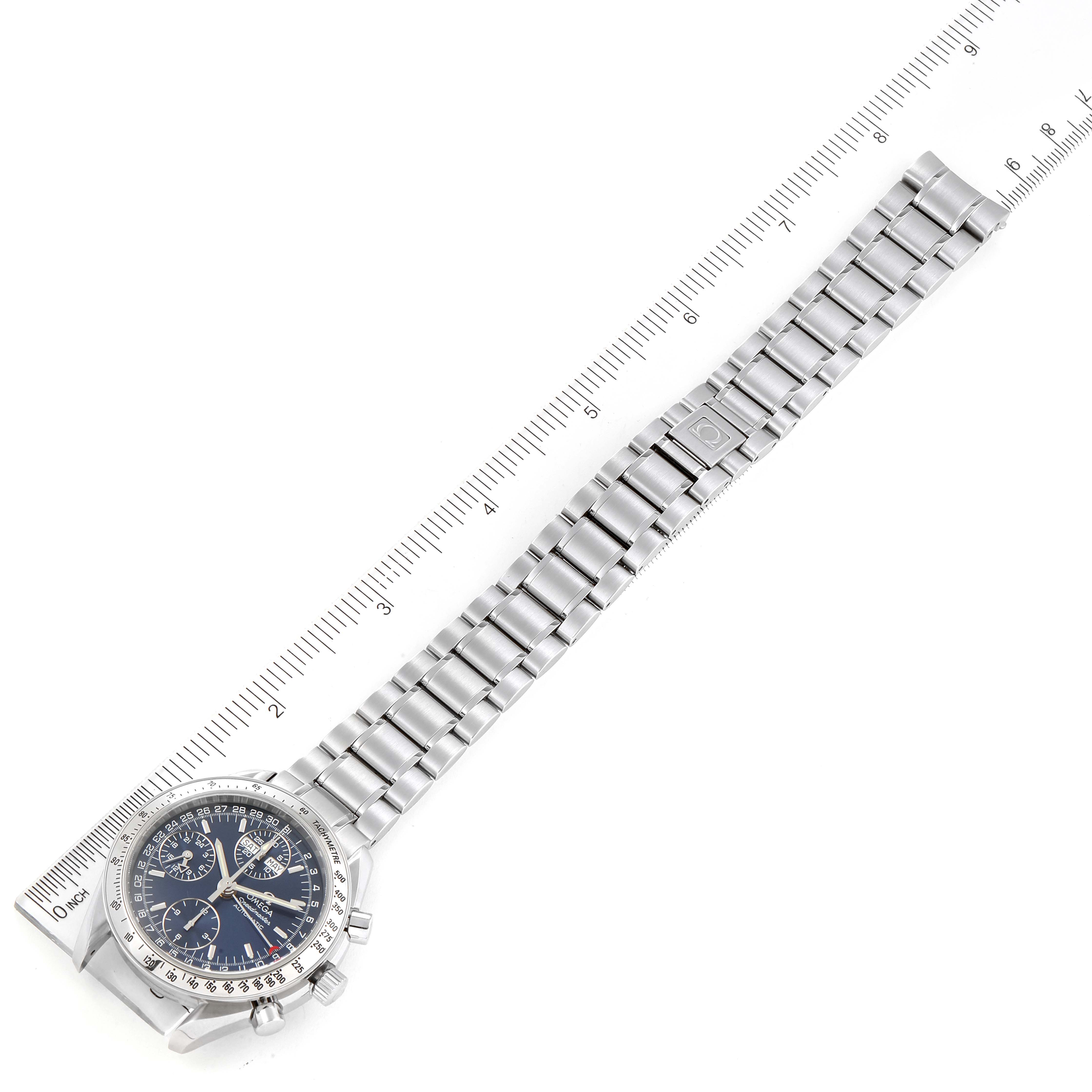 The Omega Speedmaster 3523.80.00 Men
s Stainless Steel Blue Dial 3523.80.00 Men
s Stainless Steel Blue Dial watch is shown from a top-down angle, displaying its entire face and metal bracelet against a ruler for scale.