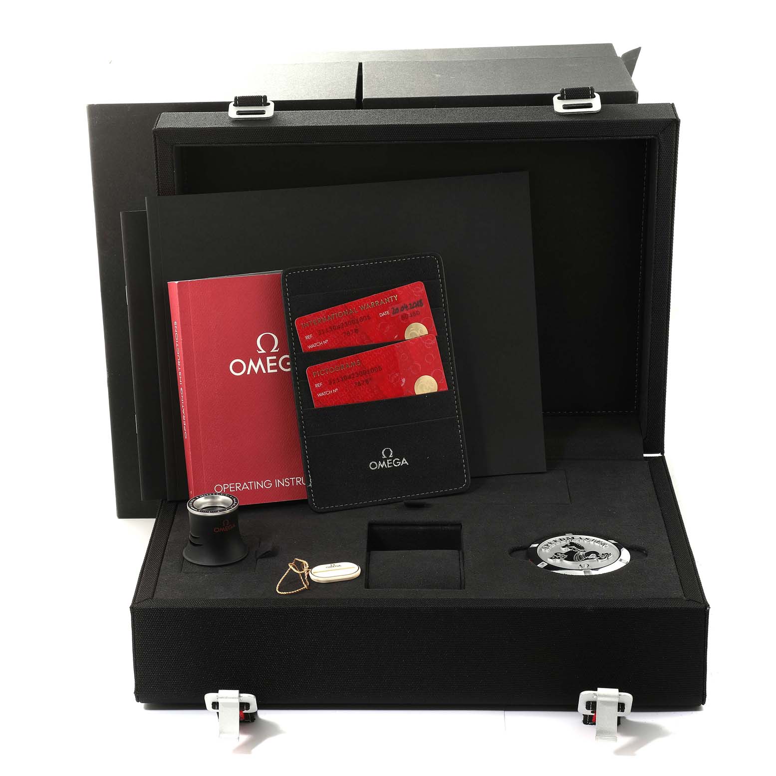 This is a top-down view of an Omega Speedmaster 311.30.42.30.01.005 Men
s Stainless Steel Black Dial 311.30.42.30.01.005 Men
s Stainless Steel Black Dial watch box showing the warranty cards, instruction manual, loupe, and watch accessories.