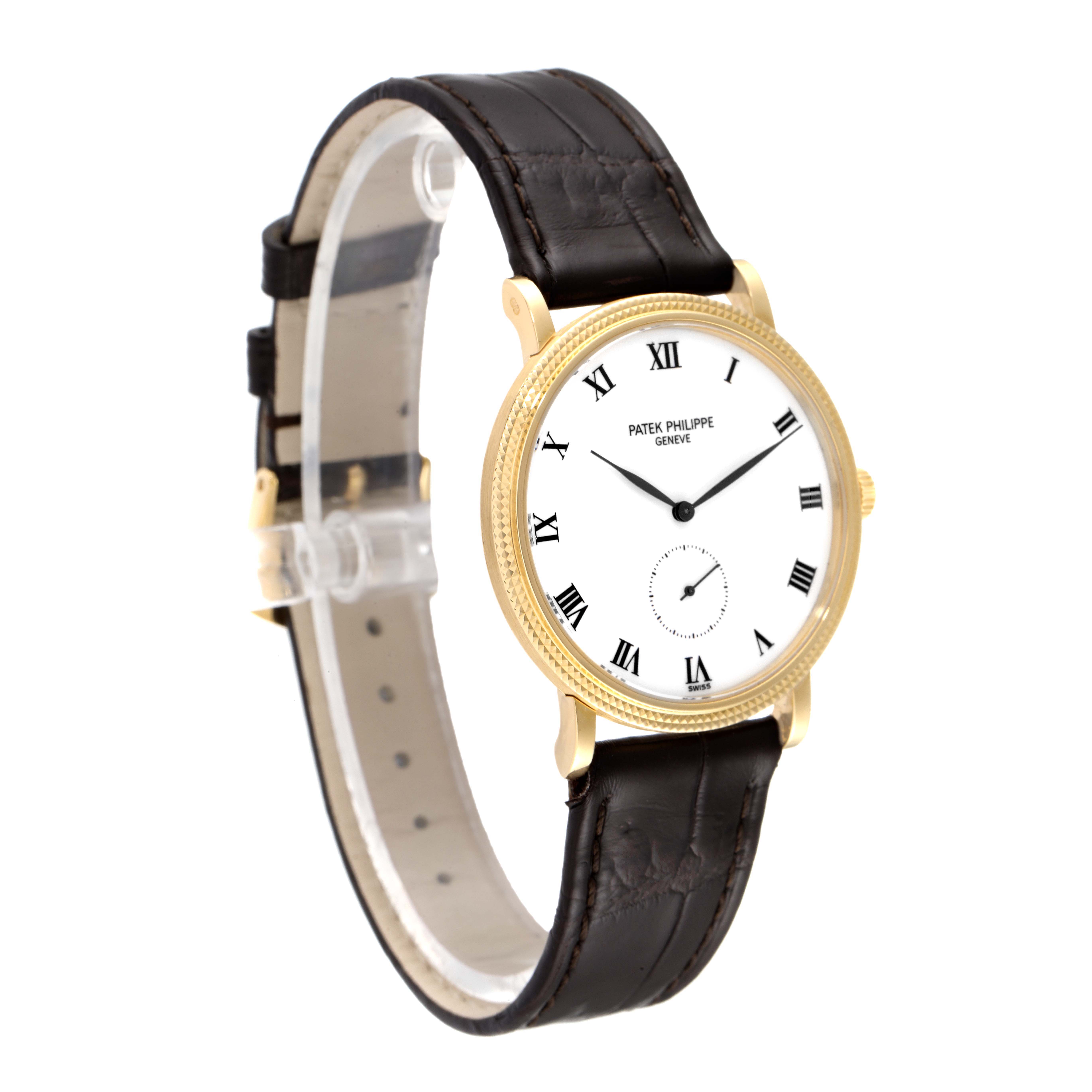 The image shows a Patek Philippe Calatrava 3919J Men's Yellow Gold White Dial 3919J Men's Yellow Gold White Dial watch from a slightly angled side view, highlighting its face, Roman numeral markers, and leather strap.