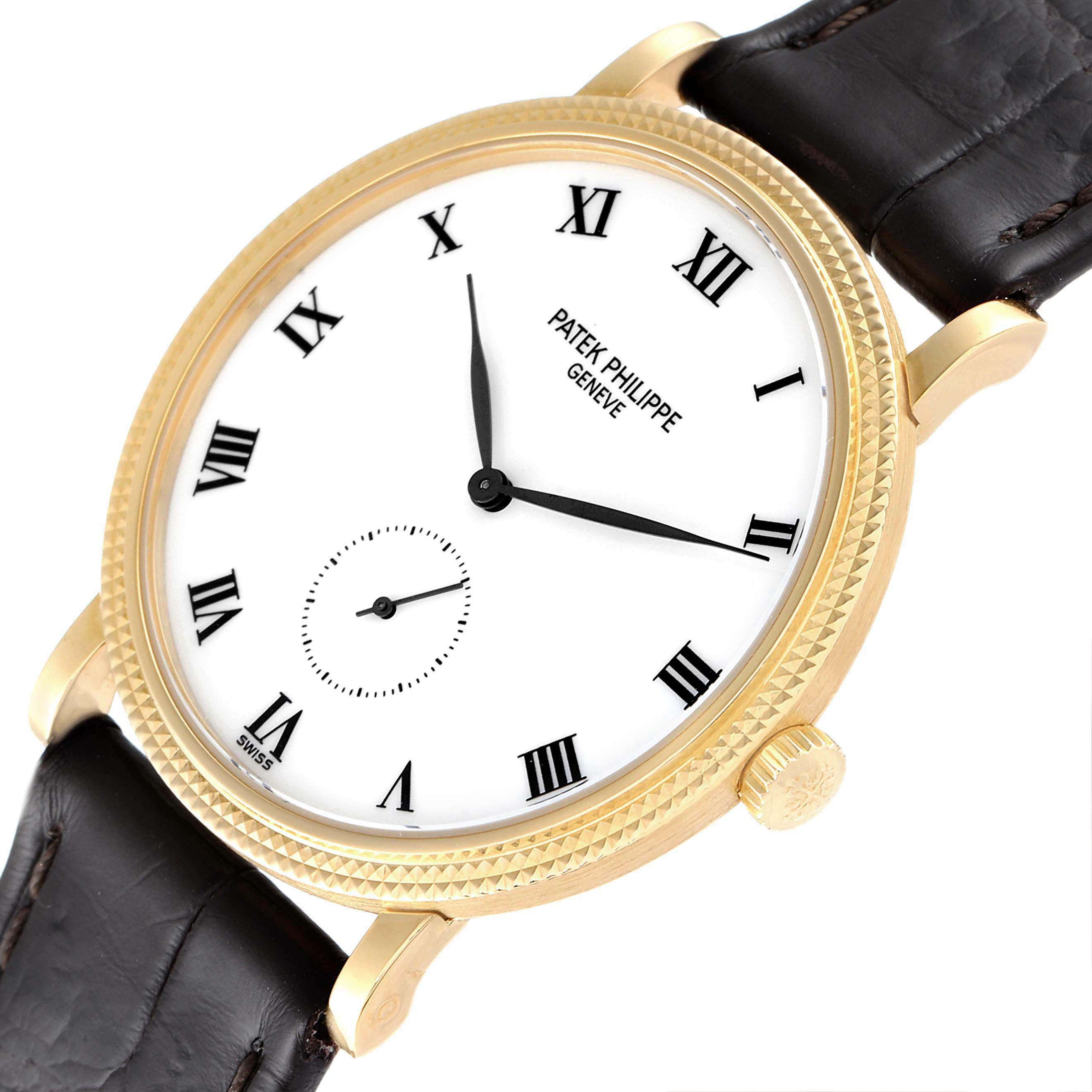 The image shows a close-up angle of the Patek Philippe Calatrava 3919J Men's Yellow Gold White Dial 3919J Men's Yellow Gold White Dial watch displaying its dial, bezel, crown, and leather strap.