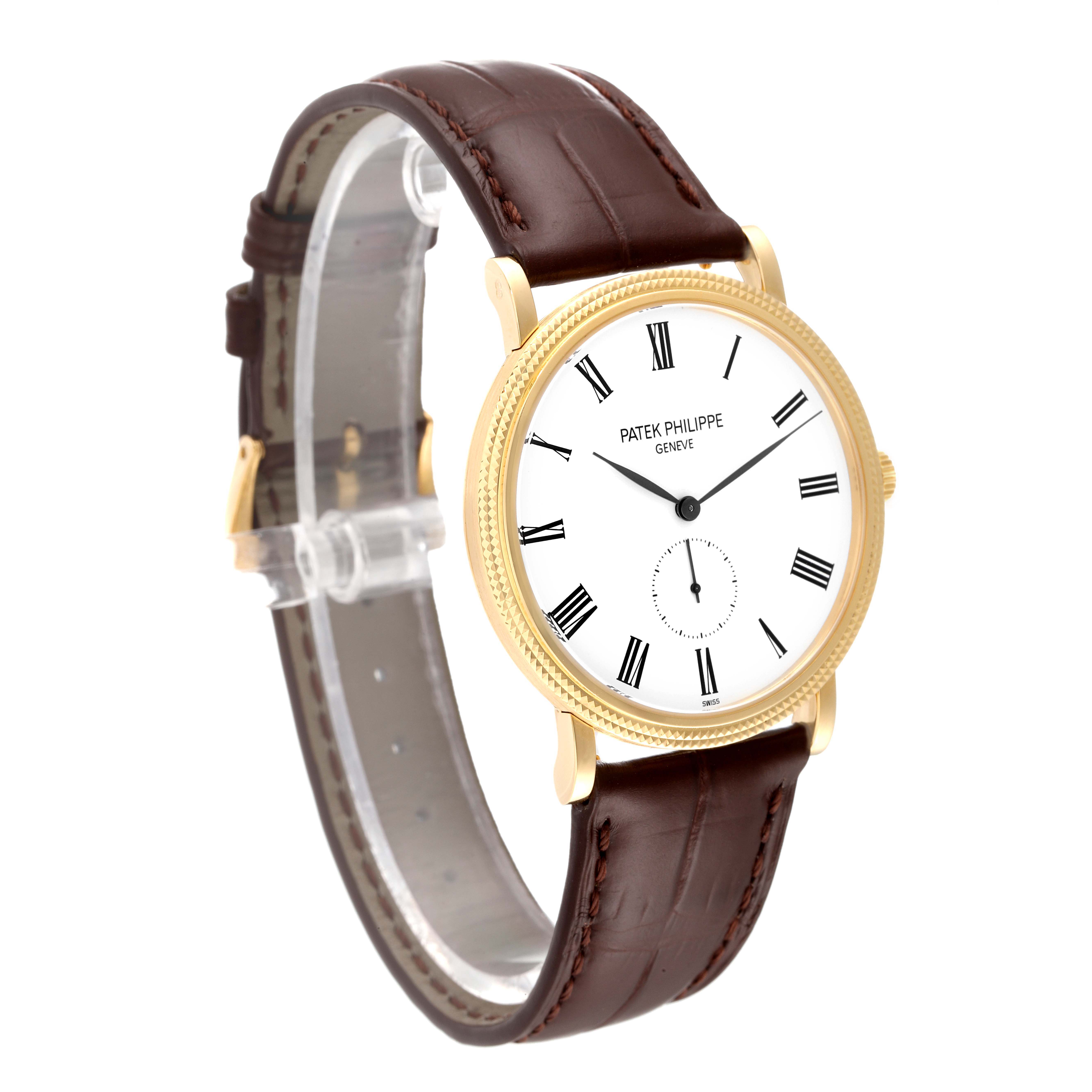 This image shows a Patek Philippe Calatrava 5119J Men's Yellow Gold White Dial 5119J Men's Yellow Gold White Dial watch from an angled side view, highlighting the face, bezel, and brown leather strap.