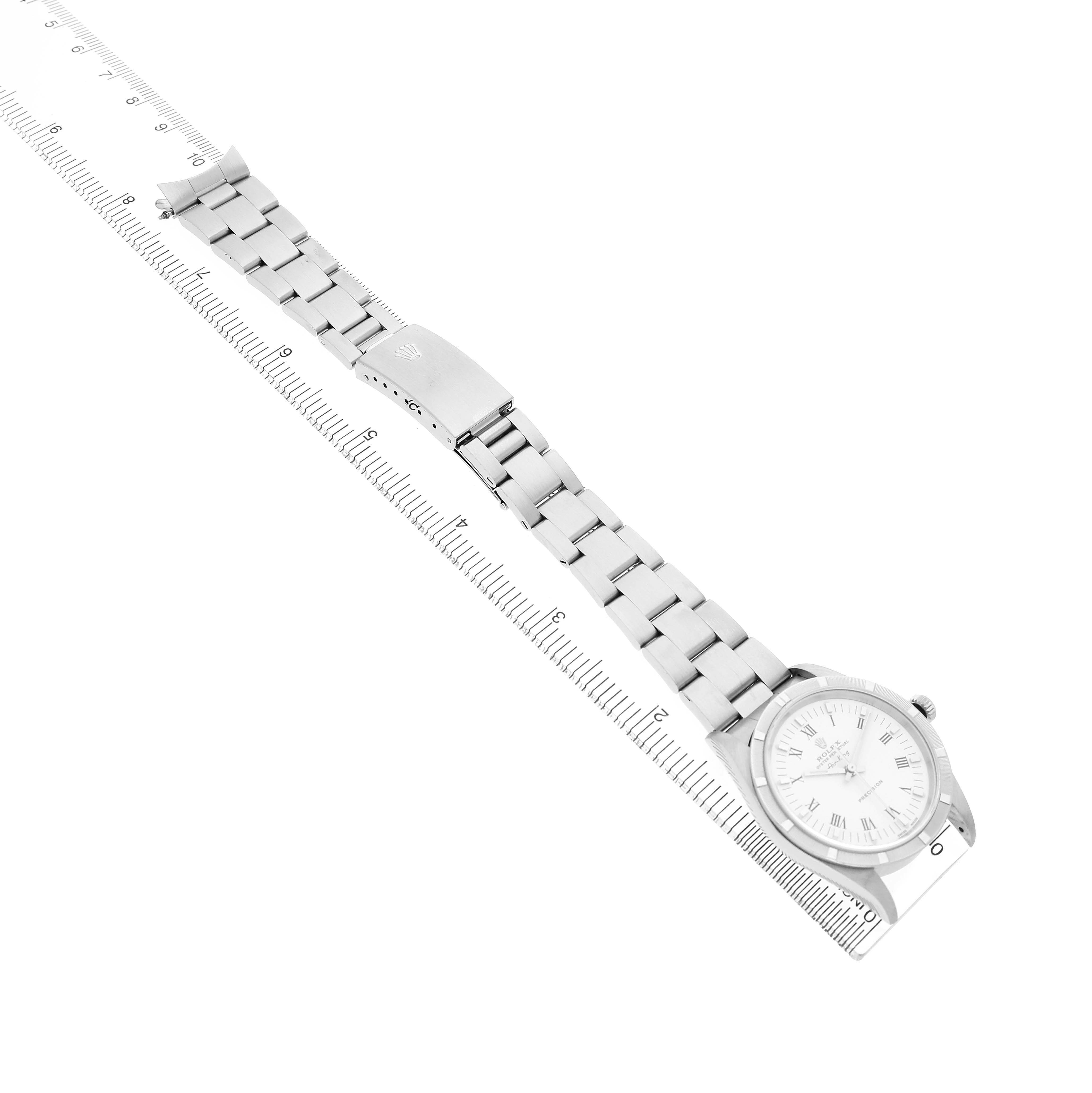 The Rolex Air-King 14010 Men's Stainless Steel White Dial watch is shown from an angled top-down view, displaying the face and band with a ruler beneath.