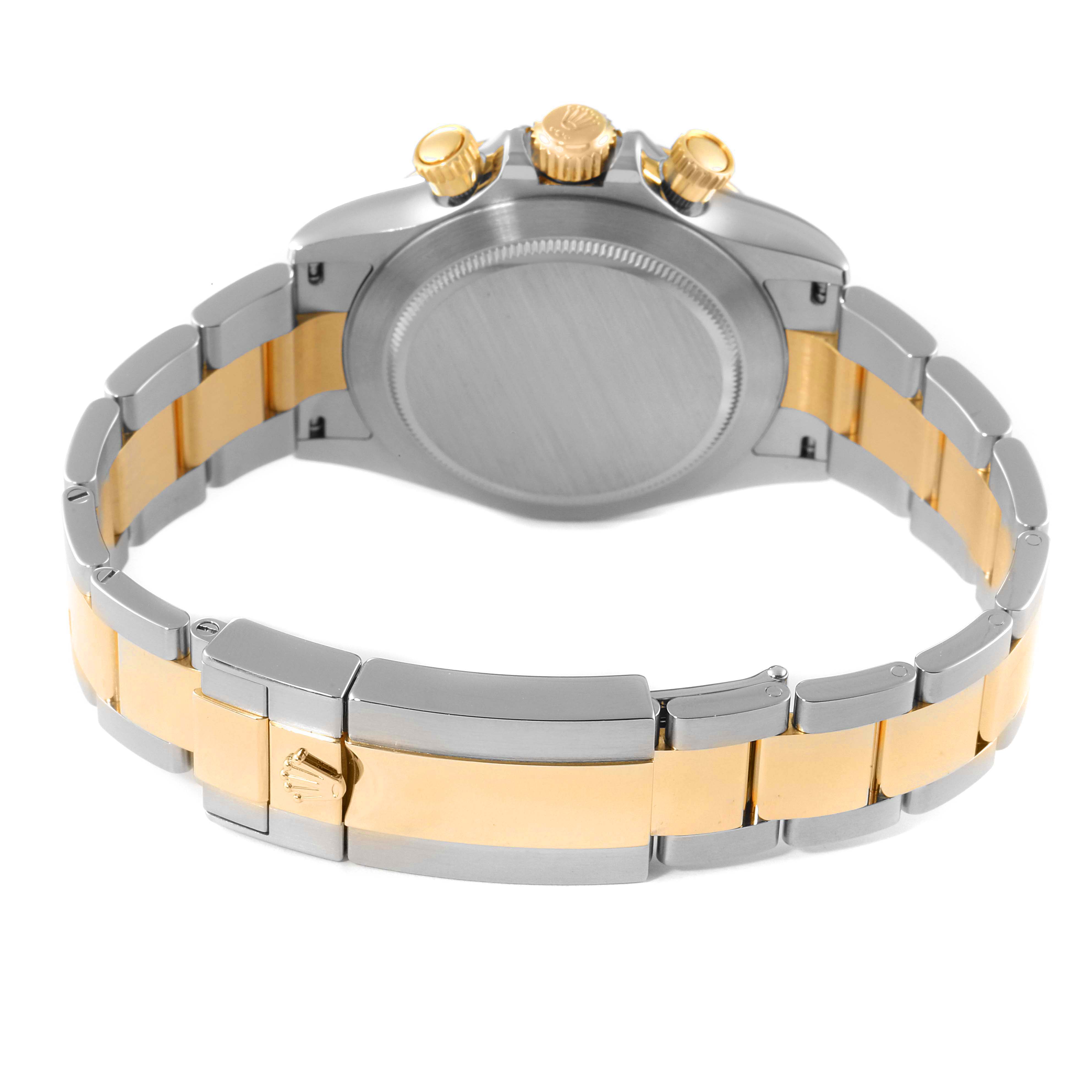 This Rolex Daytona 116503 Men's Steel and Gold (two tone) White Dial 116503 Men's Steel and Gold (two tone) White Dial watch is shown from the back, highlighting the caseback and two-tone bracelet with a clasp.