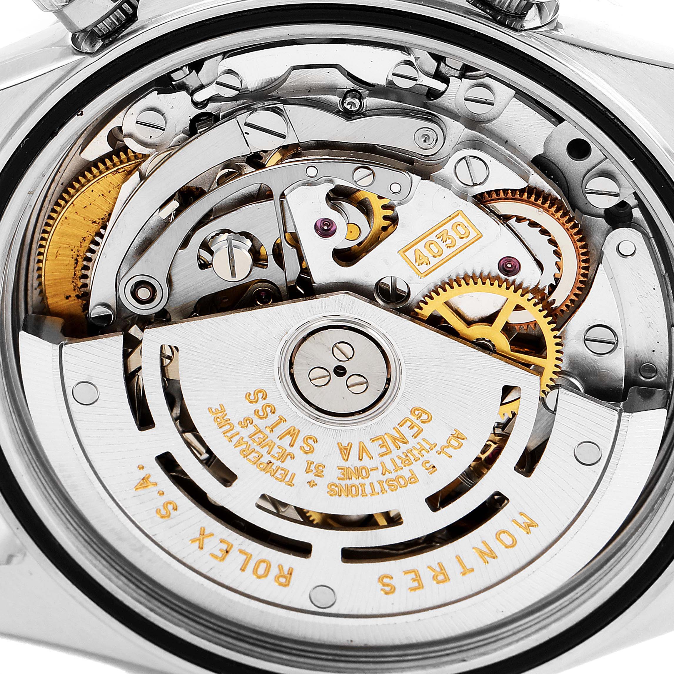 The image shows a close-up view of the movement inside a Rolex Daytona 16520 Men's Stainless Steel White Dial 16520 Men's Stainless Steel White Dial watch, highlighting its intricate inner workings and gears.