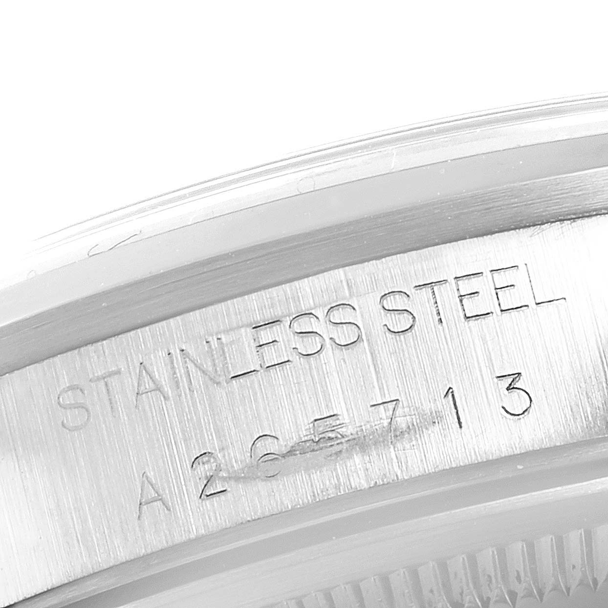 The image shows a close-up of the inner casing of a Rolex Date 15200 Men's Stainless Steel Black Dial 15200 Men's Stainless Steel Black Dial model, highlighting its stainless steel material and serial number.