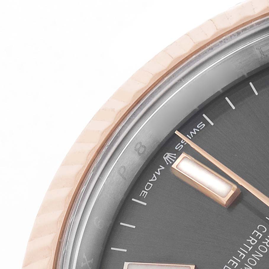 The image shows a close-up of the bezel, dial, and hands of a Rolex Datejust 126231 Men's Steel and Gold (two tone) Grey Dial watch from an angled side view.