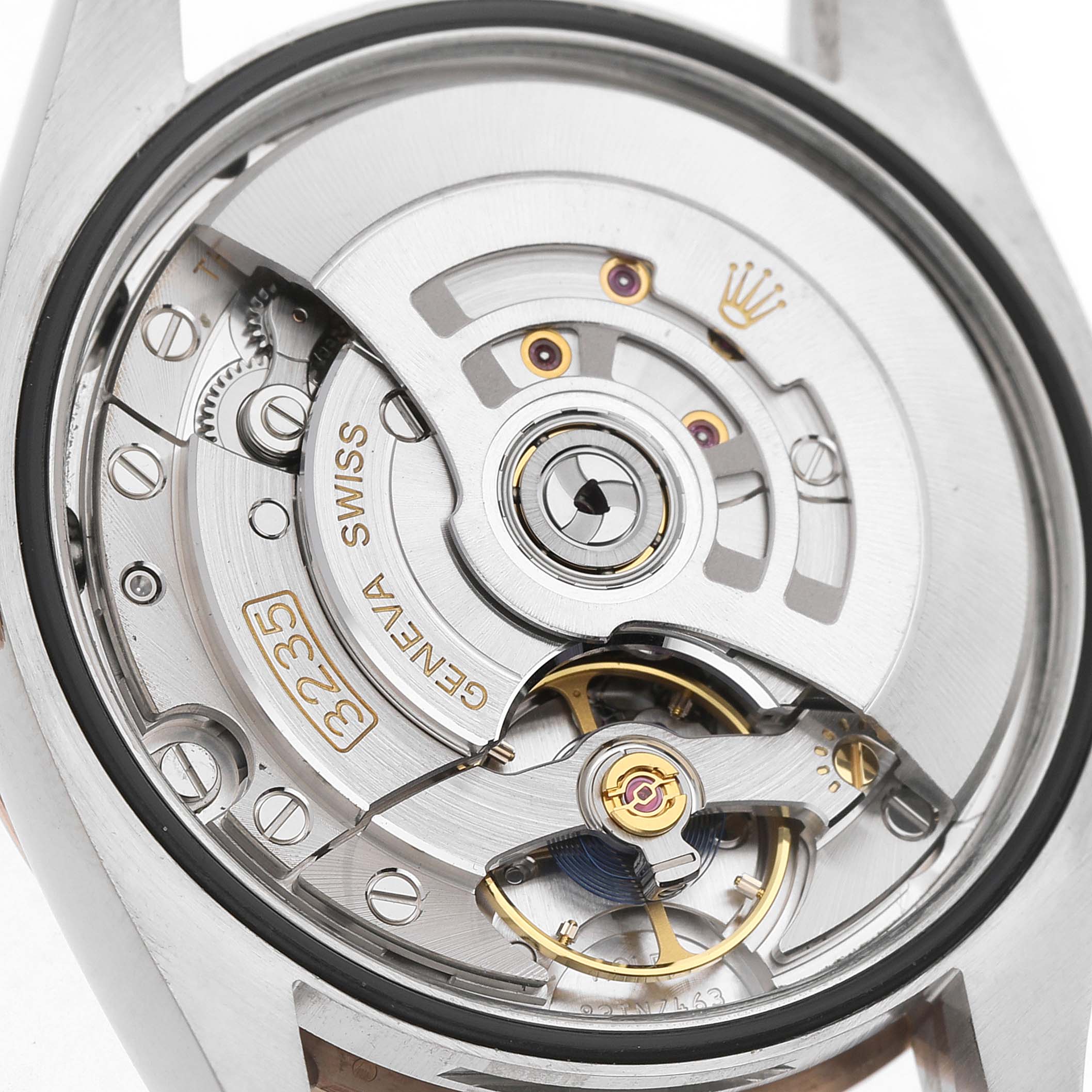 The image shows the movement of a Rolex Datejust 126231 Men's Steel and Gold (two tone) Grey Dial, viewed from the back, highlighting the rotor and balance wheel.