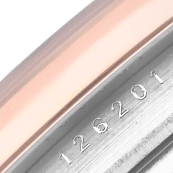 This close-up image of the Rolex Datejust 126201 Men's Steel and Gold (two tone) Grey Dial 126201 Men's Steel and Gold (two tone) Grey Dial watch shows part of the bezel and the engraved reference number 126201.