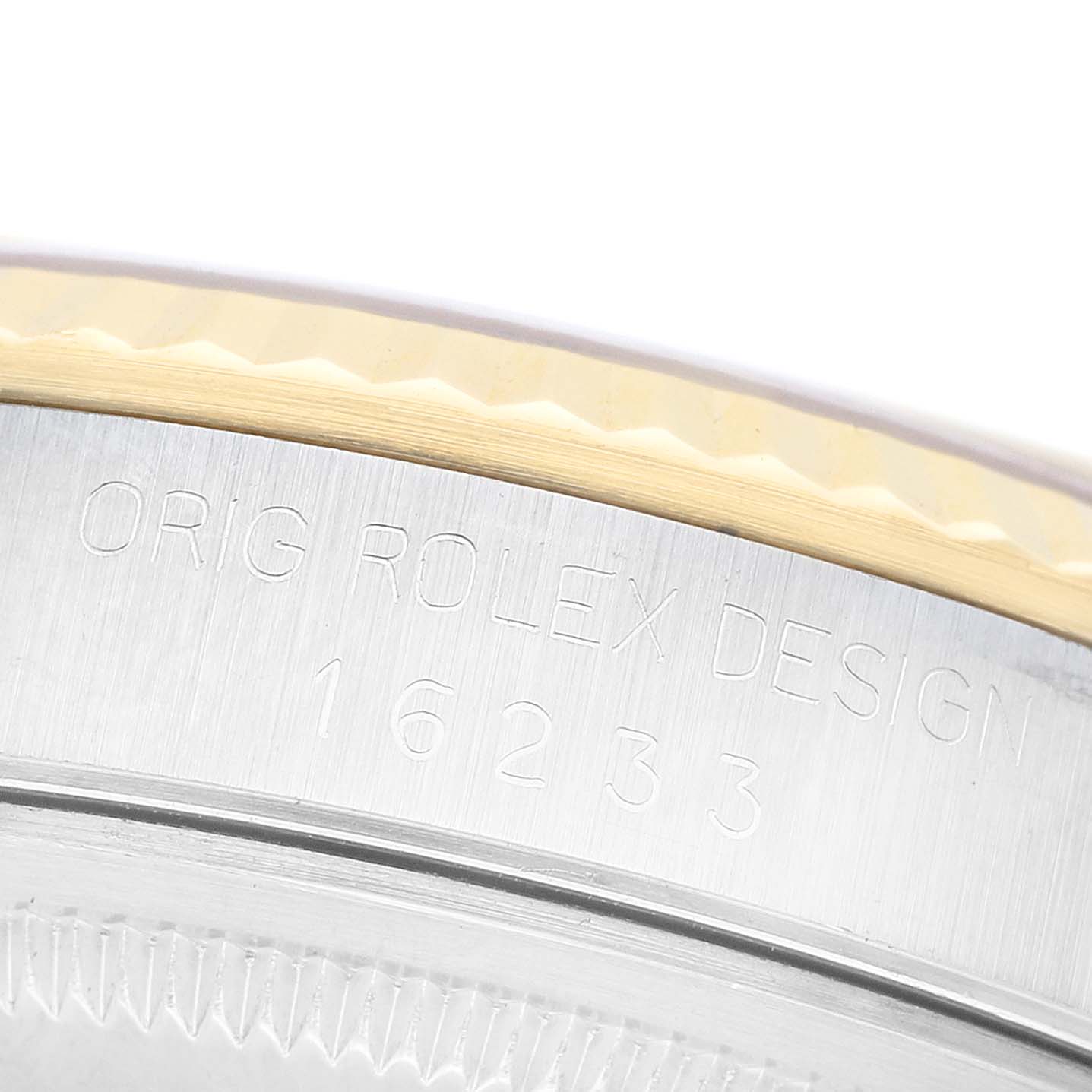 The image shows a close-up of the side of a Rolex Datejust 16233 Men's Steel and Gold (two tone) Champagne Dial watch, highlighting the model number and engraved "ORIG ROLEX DESIGN."