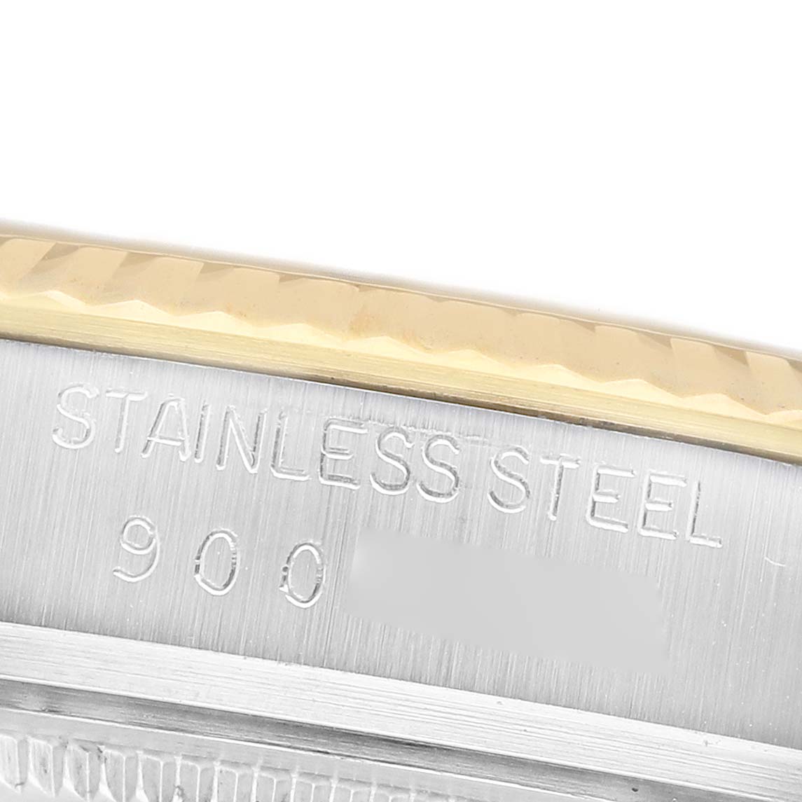 The image shows a close-up of the case back edge of a Rolex Datejust 16013 Men's Steel and Gold (two tone) Champagne Dial, highlighting the bezel and "STAINLESS STEEL" engraving.