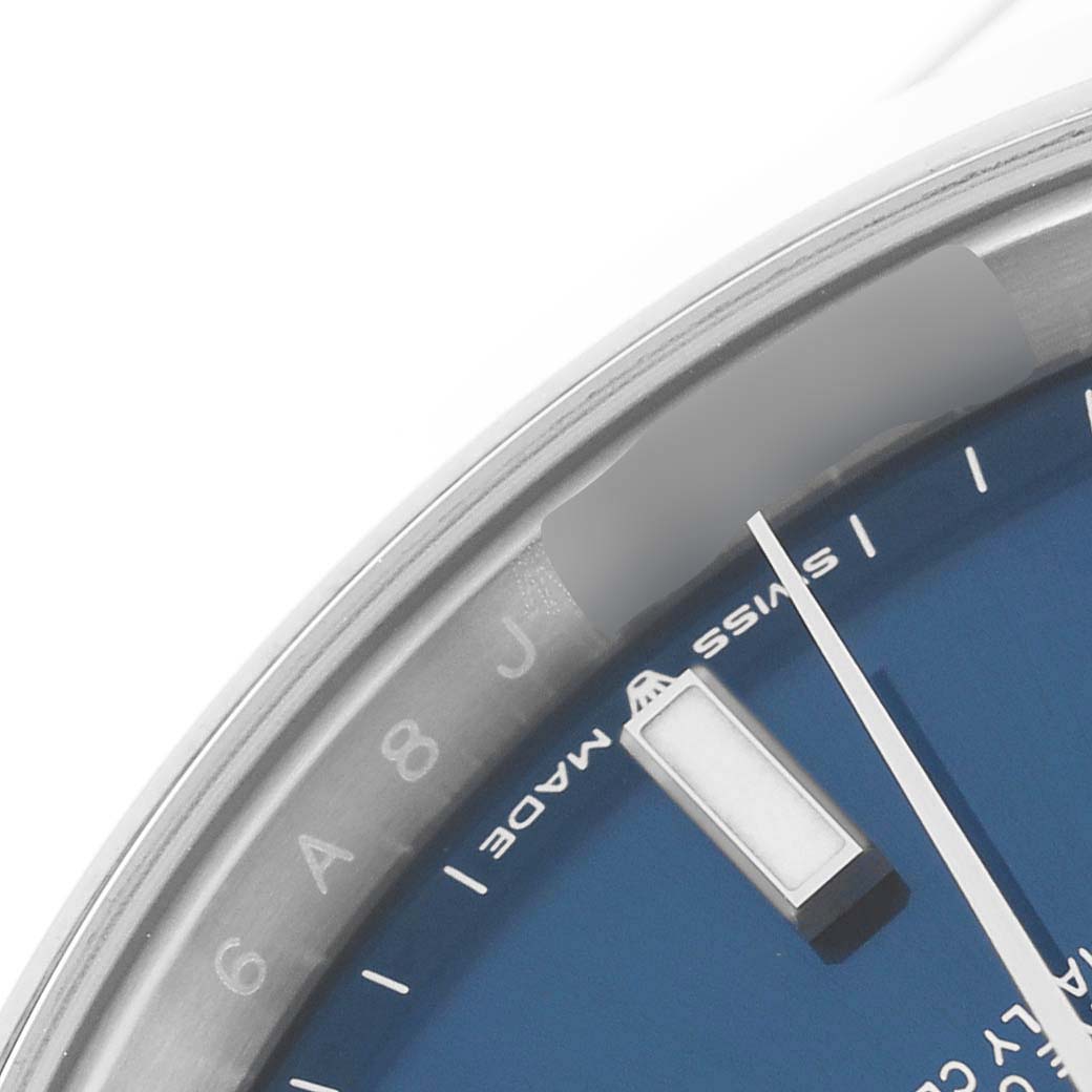 This image shows a close-up of the upper left part of the dial of a Rolex Datejust 41 126300 Men
s Stainless Steel Blue Dial 126300 Men
s Stainless Steel Blue Dial, including the indices and part of the "Swiss Made" text.